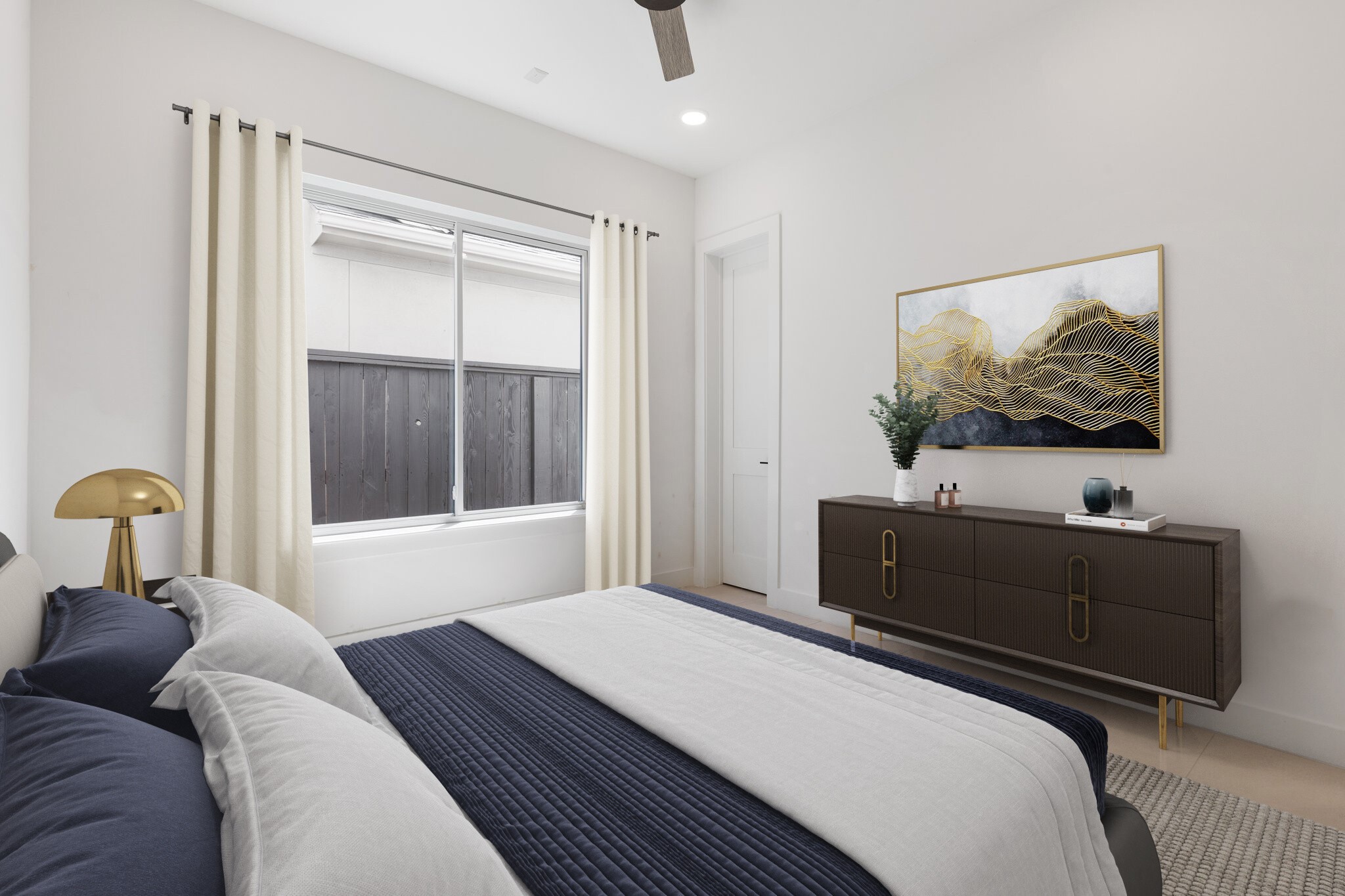 This spacious secondary bedroom #2 on the first floor offers a Visual Comfort ceiling fan, large window, and recessed can lighting. With an electrical outlet for a future TV and a generous walk-in closet with built-in dresser, its designed for both comfort and convenience. Note: this photo has been virtually staged.