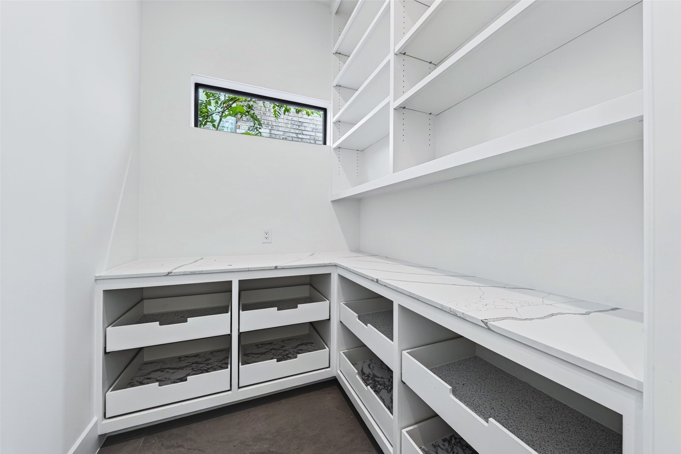 The generous walk-in pantry has shelving and drawers.