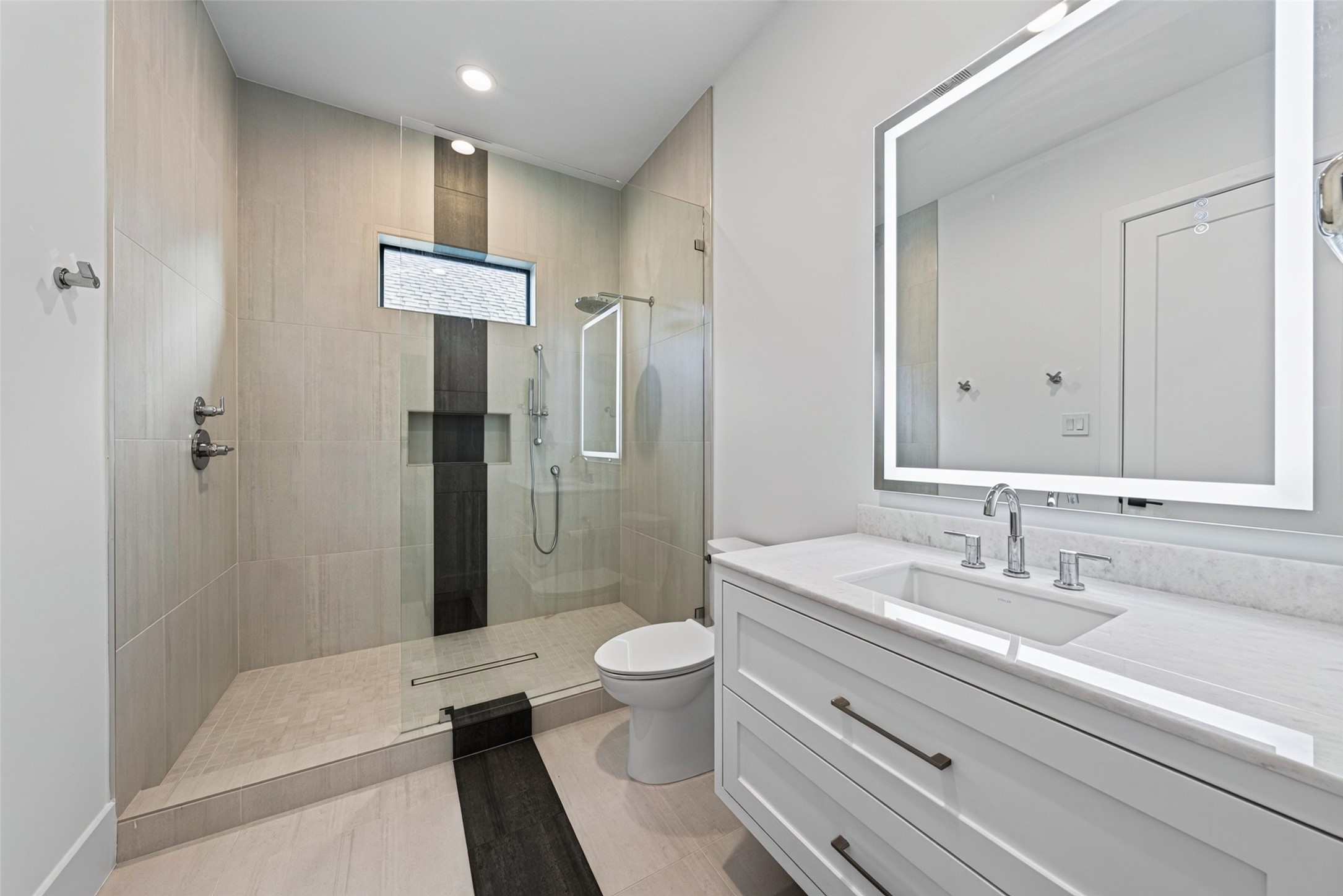 The 3rd and 4th secondary bedrooms have oversized walk in showers. All have designer bath finishes, with LED/Wi-Fi-capable, anti-fog mirrors.
