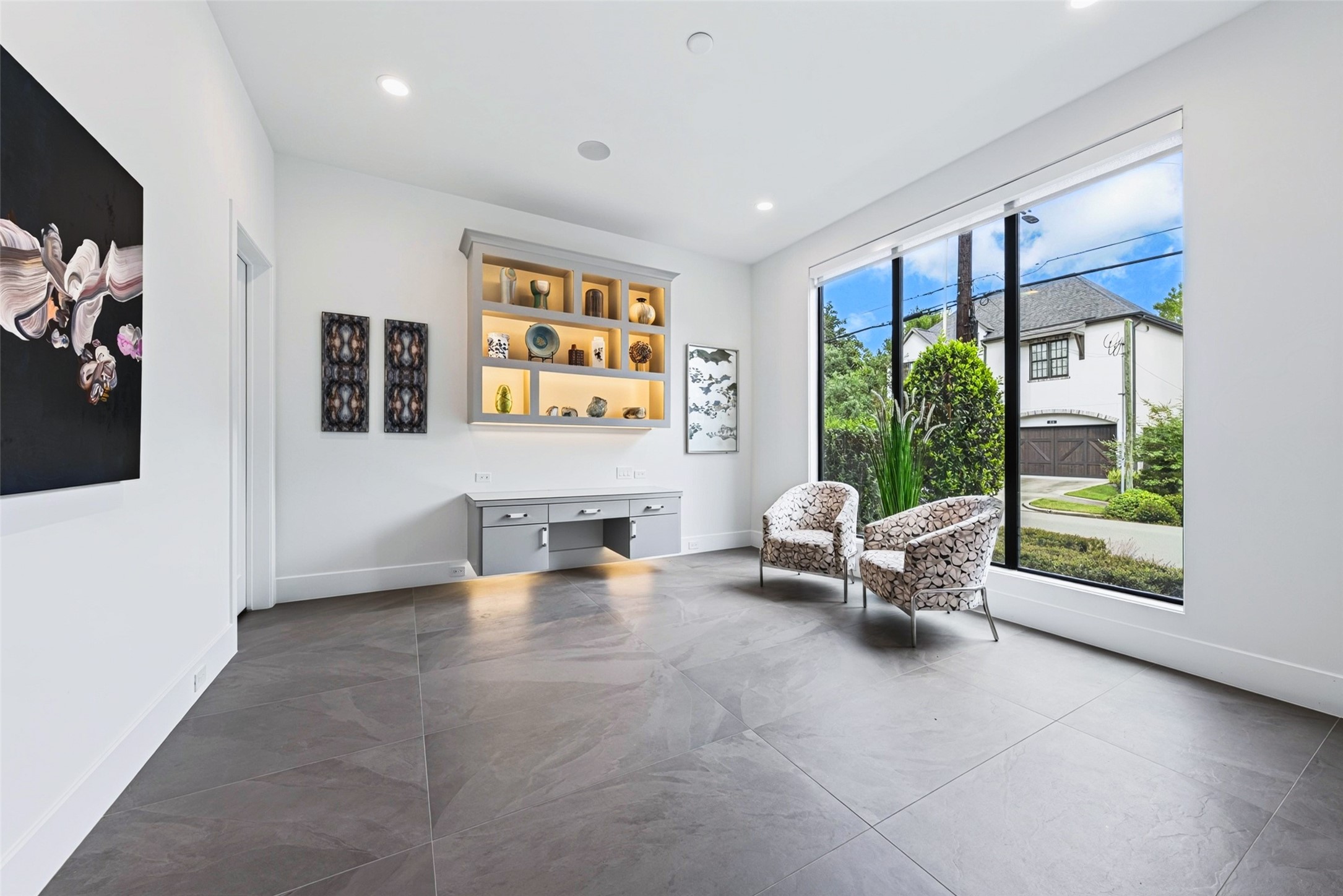 A home office is located on the first floor to the right when you enter the front door. The custom floating desk and shelving was added in 2024. There is a huge closet beyond the door to the left that houses the home automation hub.