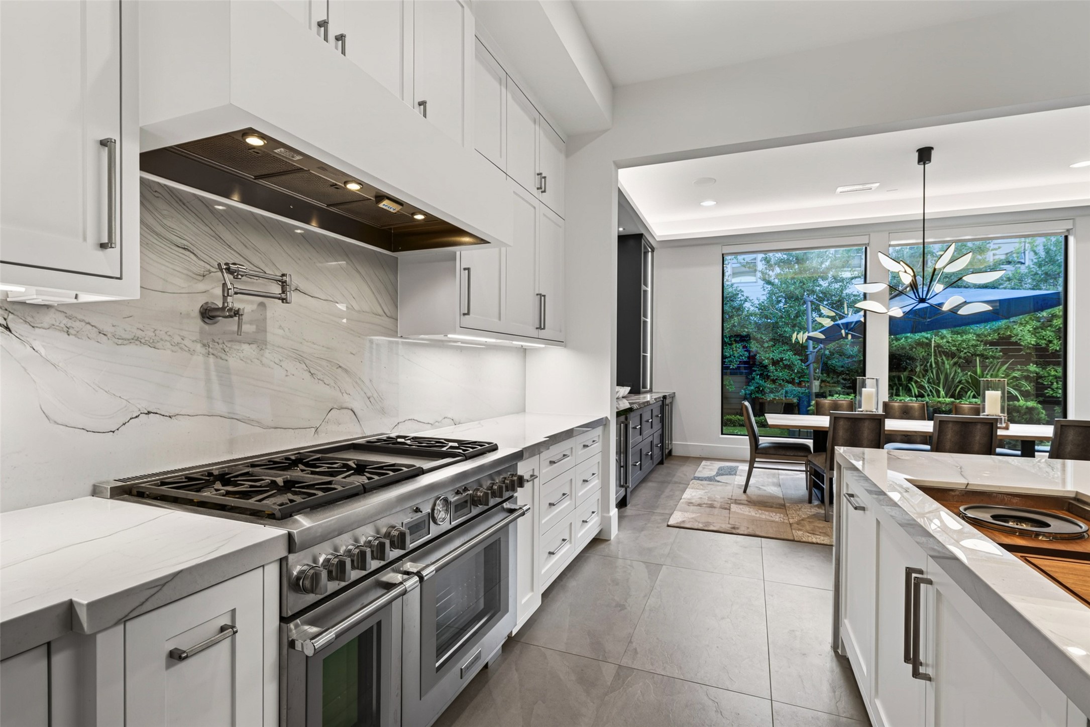 A Thermador six burner with griddle and double ovens add to this chef style kitchen.