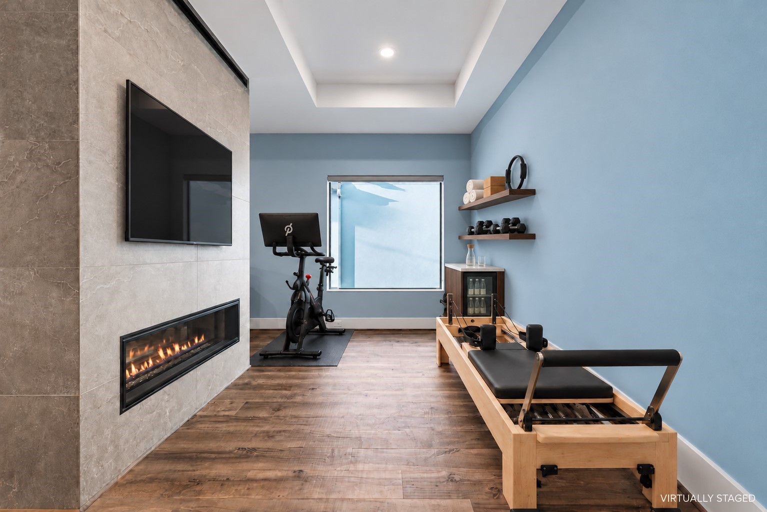 A private space for movement and renewal, envisioned within the primary suite. This virtually rendered pairs a Peloton and Pilates reformer with a beverage station. This flex space can accommodate many options.

Virtually staged for inspiration. Equipment, furnishings, shelving, beverage fridge, and TV are not existing features.