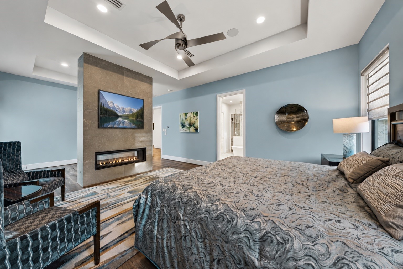 A double-sided gas fireplace, wrapped in Italian porcelain tile, is a focal point and separates the flex space.