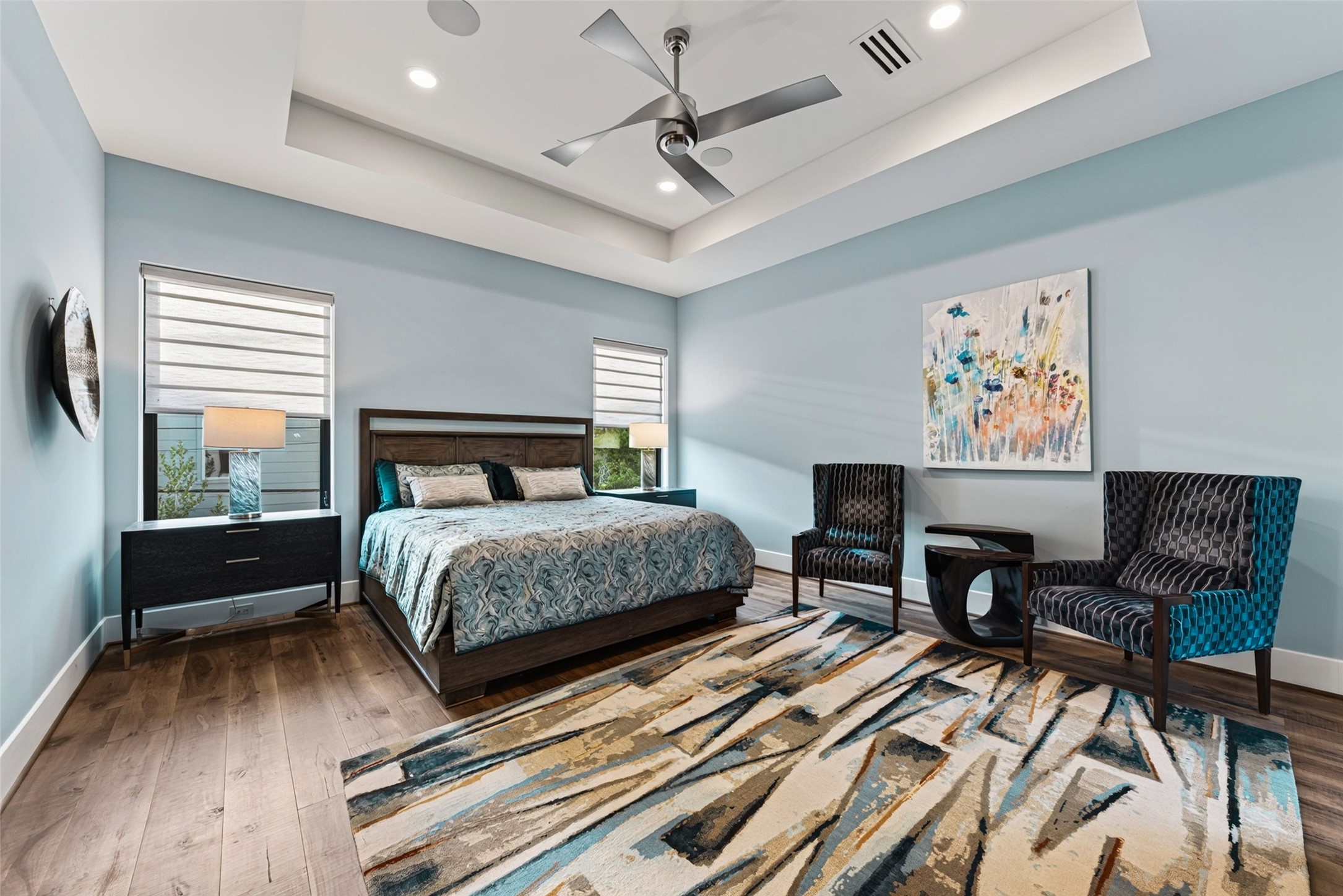 The spacious primary suite has a coffered ceiling, opaque and black out programmable mechanical shades and surround sound.