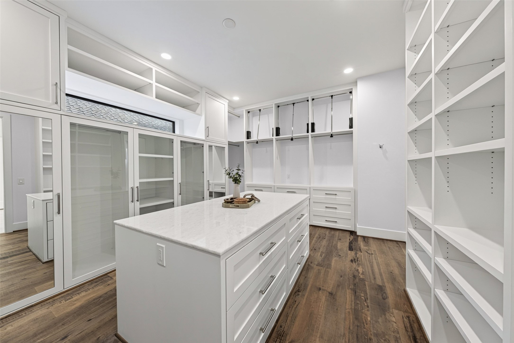 The custom primary closet has abundant shelving, drawers and hang space and 2 full length mirrors. It also has has integrated surround sound.