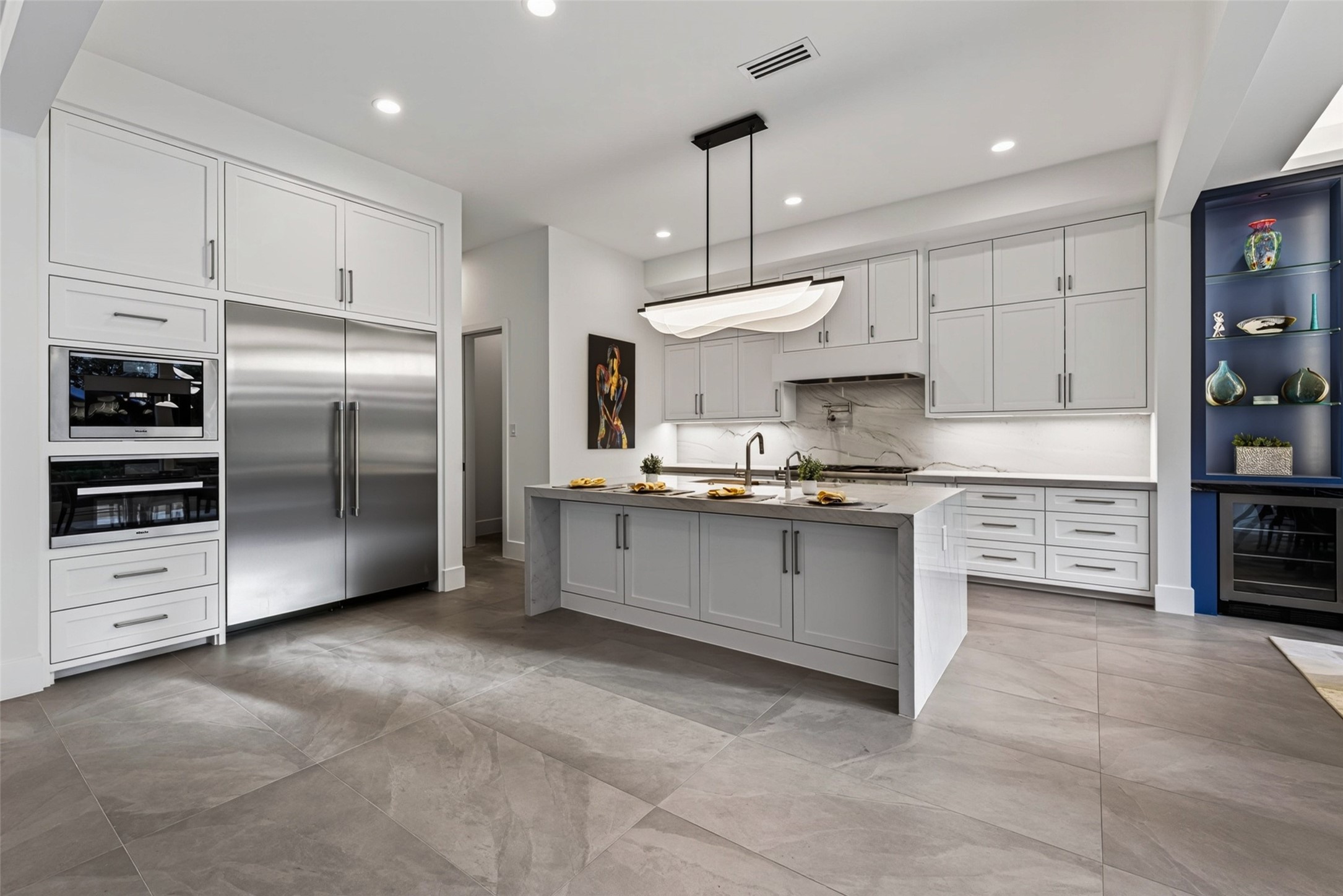 The kitchen features separate tower Thermador refrigerator and freezer, and the Miele speed oven and built in coffee systems are fabulous for entertaining.