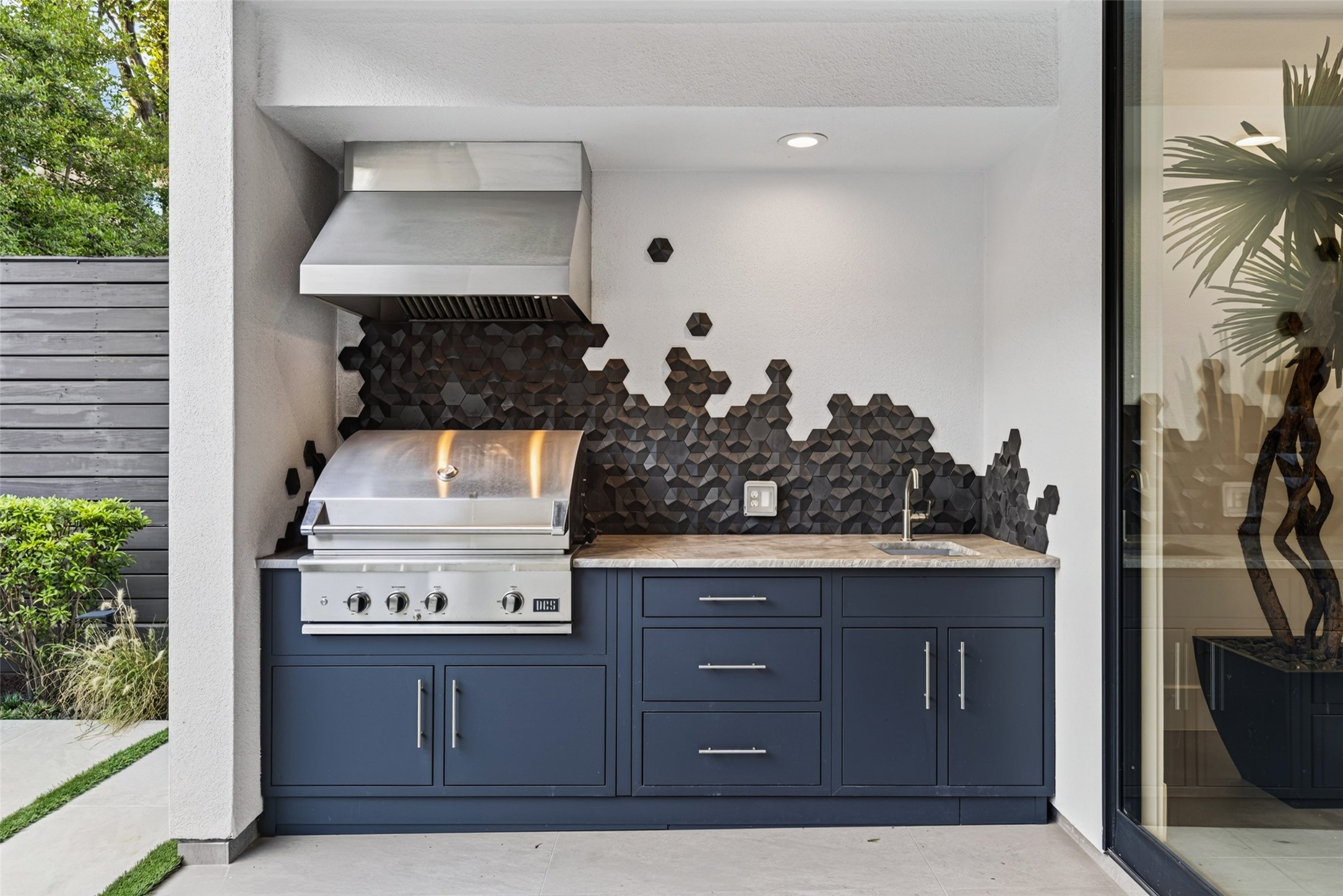 An artfully designed outdoor kitchen was added in 2024 with a DCS built-in gas grill.