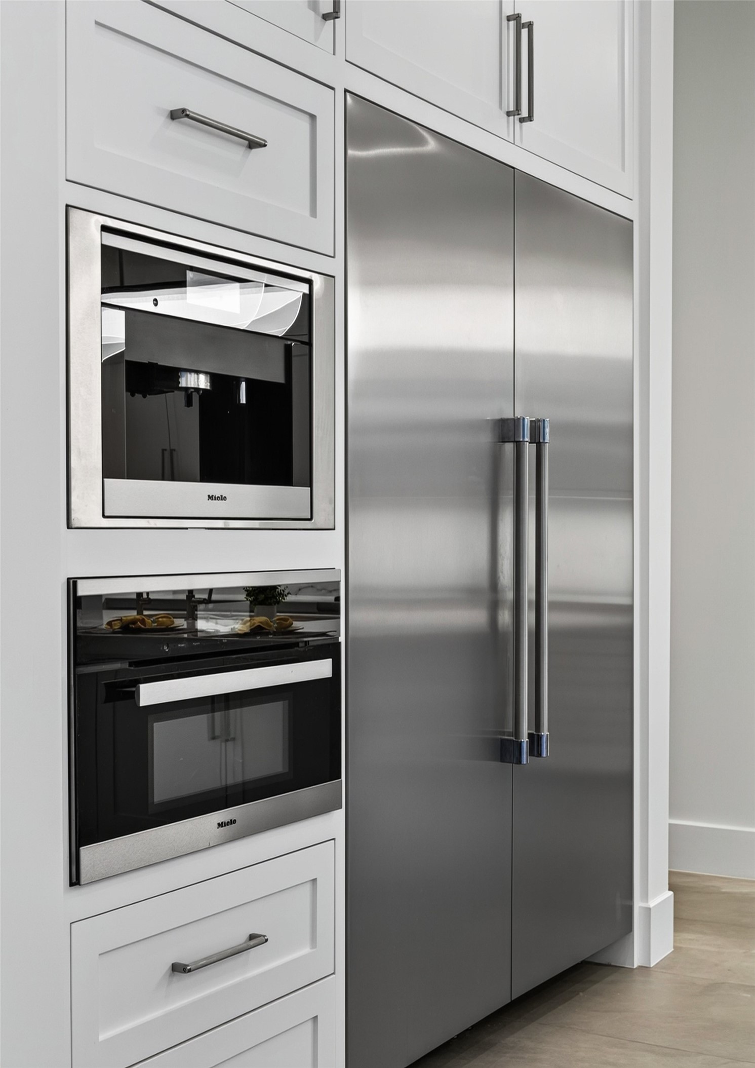 The dual Thermador tower refrigerator and freezer, and Miele speed oven and built-in coffee system are perfect for entertaining.
