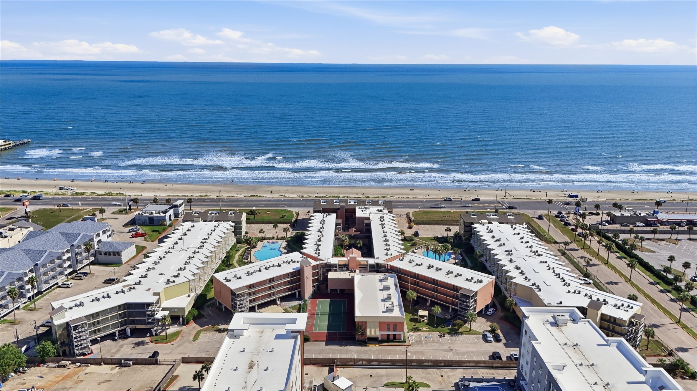 Aerial view of The Victorian on Galveston's Seawall, with the Gulf of Mexico just beyond Aerial view of The Victorian on Galveston's Seawall, with the Gulf of Mexico just beyond