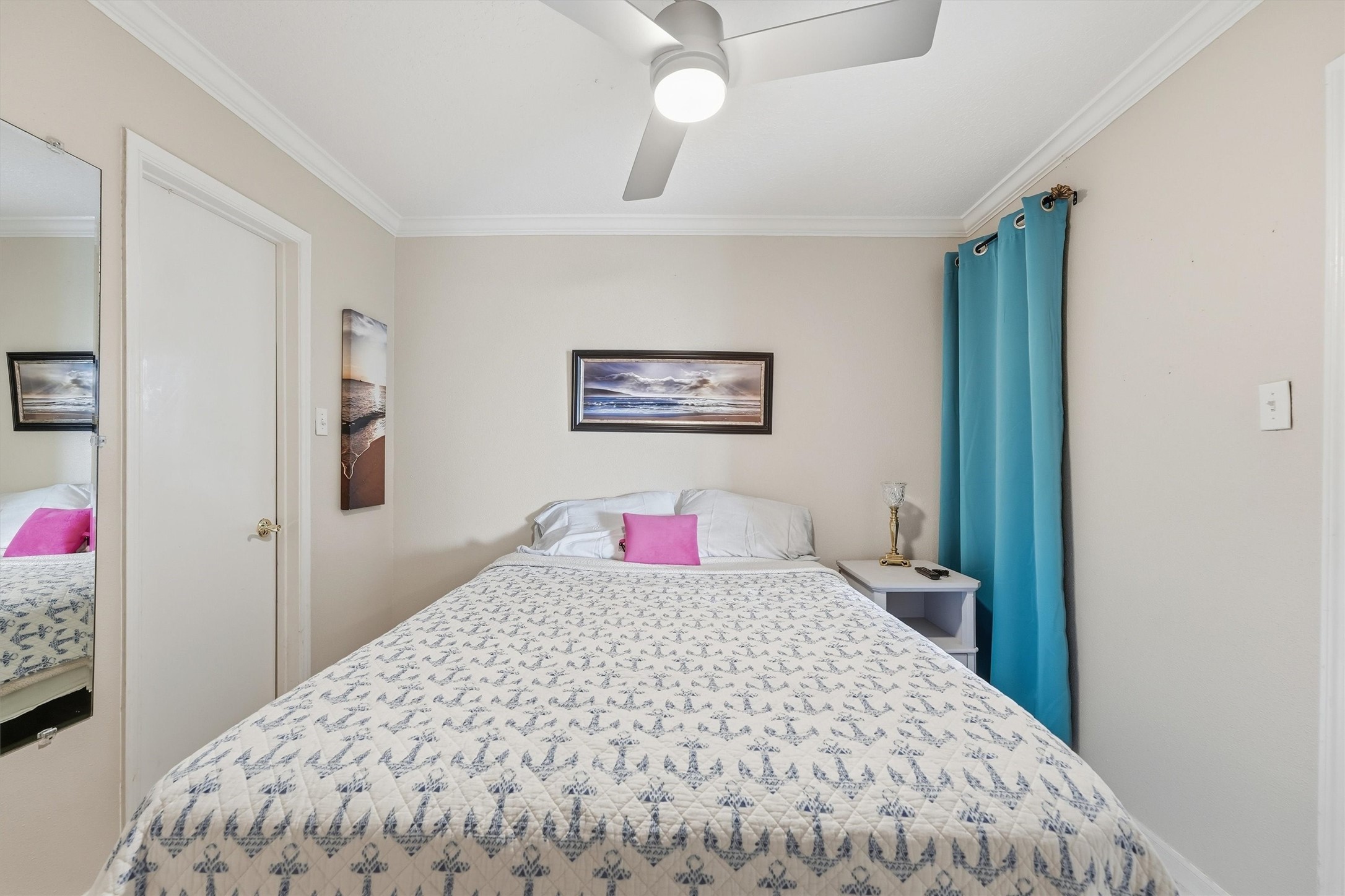 Bedroom with ceiling fan and soft coastal tones