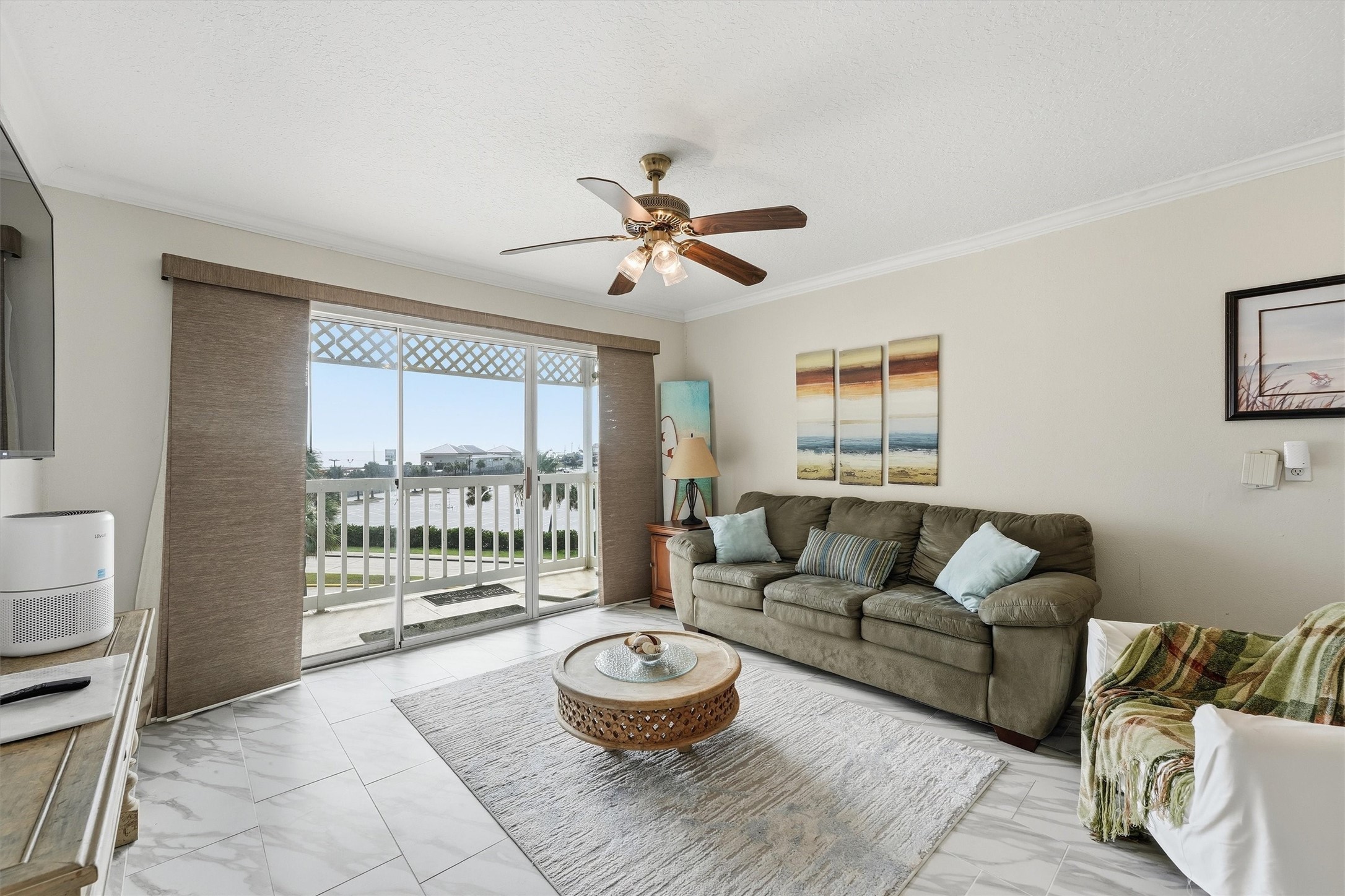Living room with sliding doors to the balcony and water views