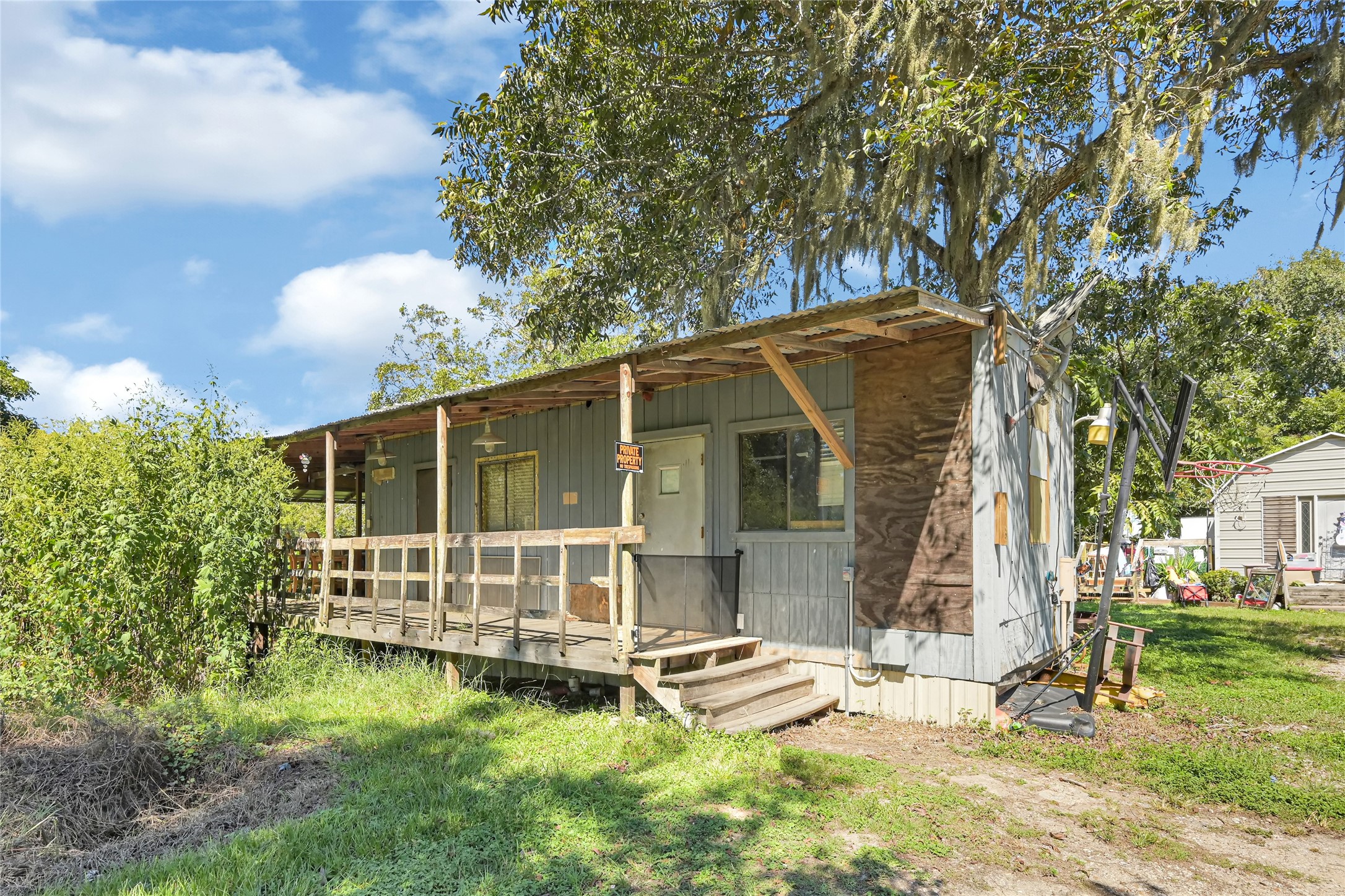 Charming rustic home with a covered porch set amidst lush greenery, offering a peaceful retreat.