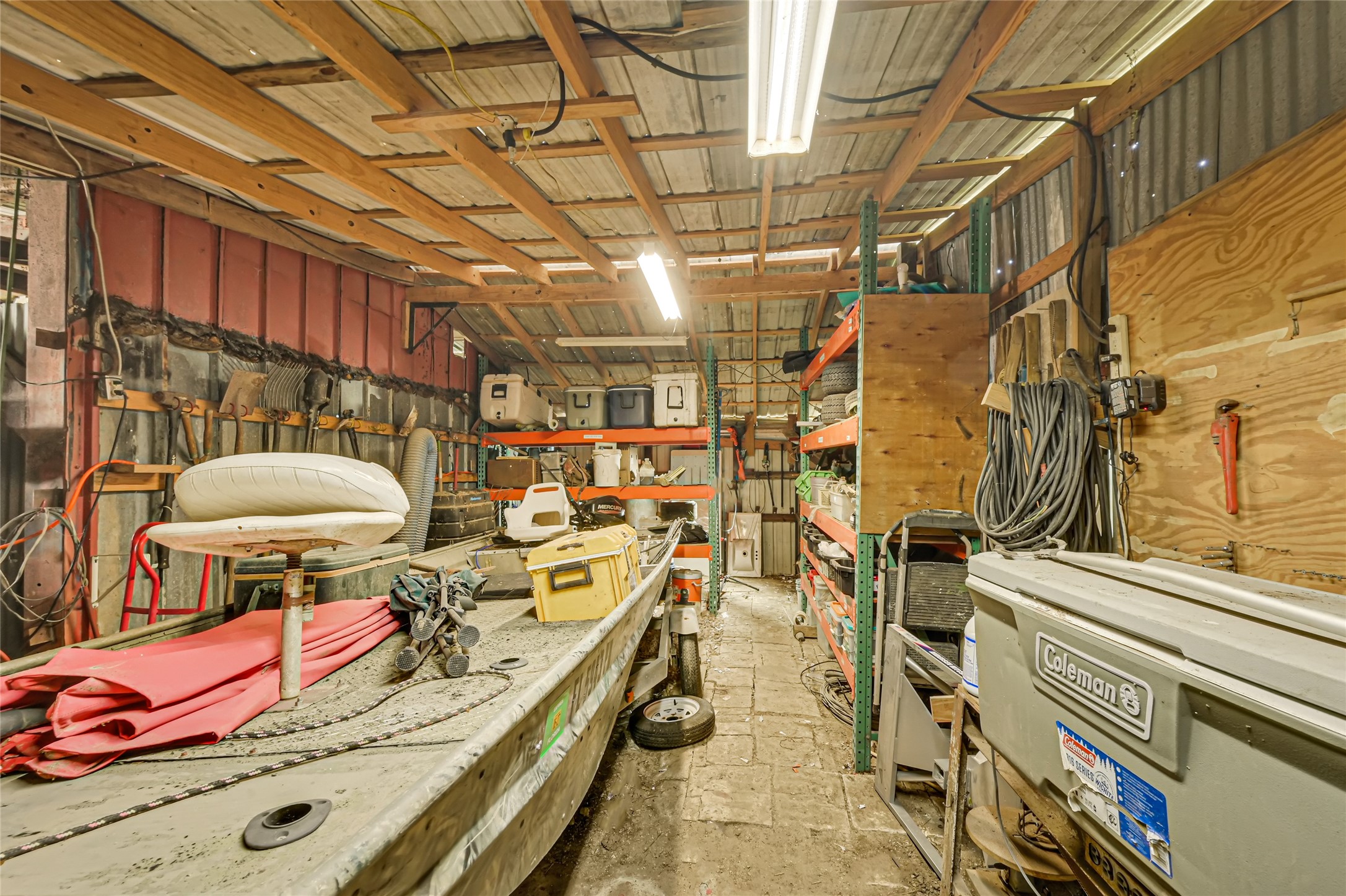 Spacious utility shed with ample shelving, perfect for storing tools, equipment, or outdoor gear.