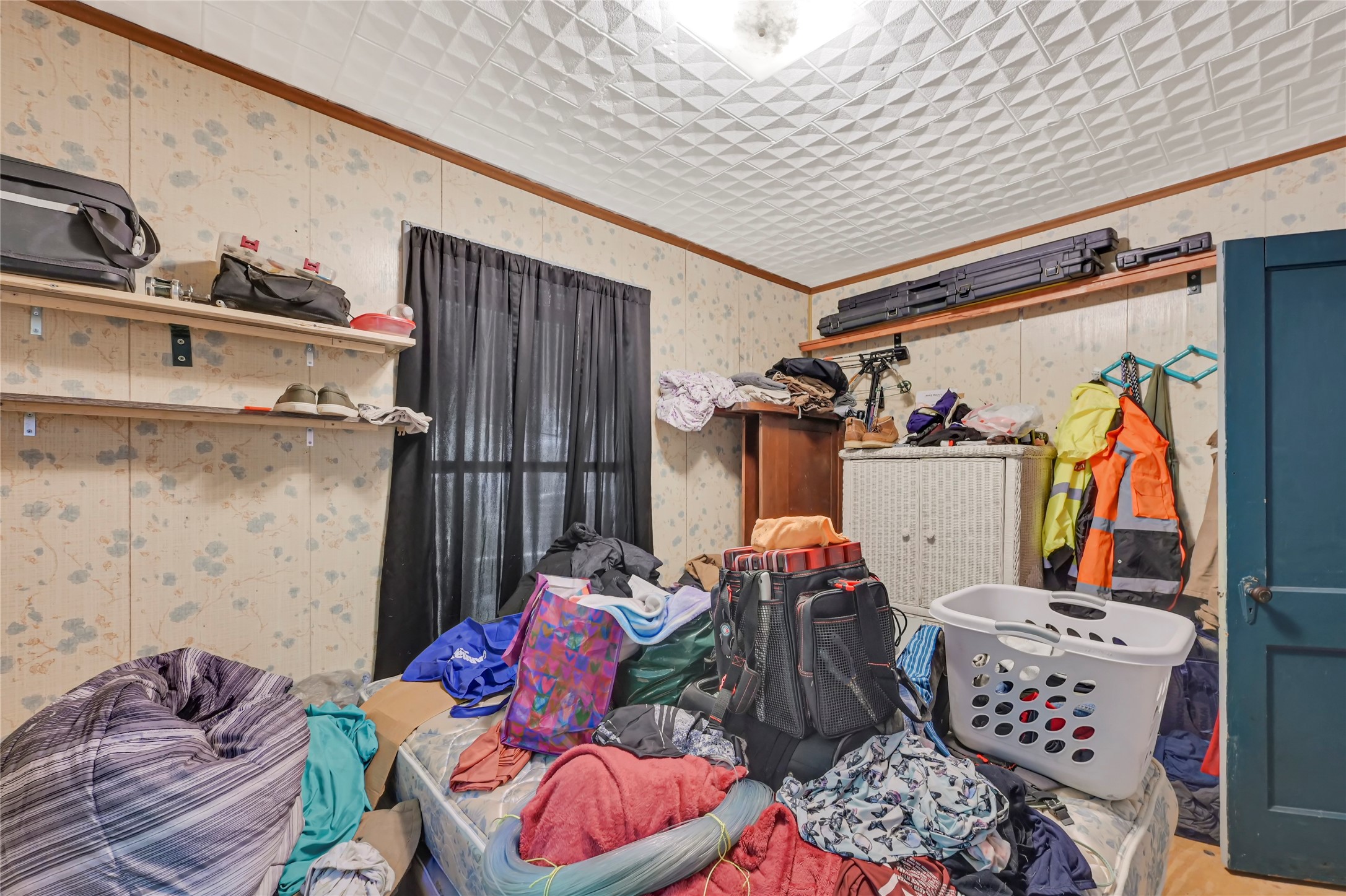 Cozy room with potential for customization, featuring built-in shelving and ample natural light, ideal for storage or a personal retreat.