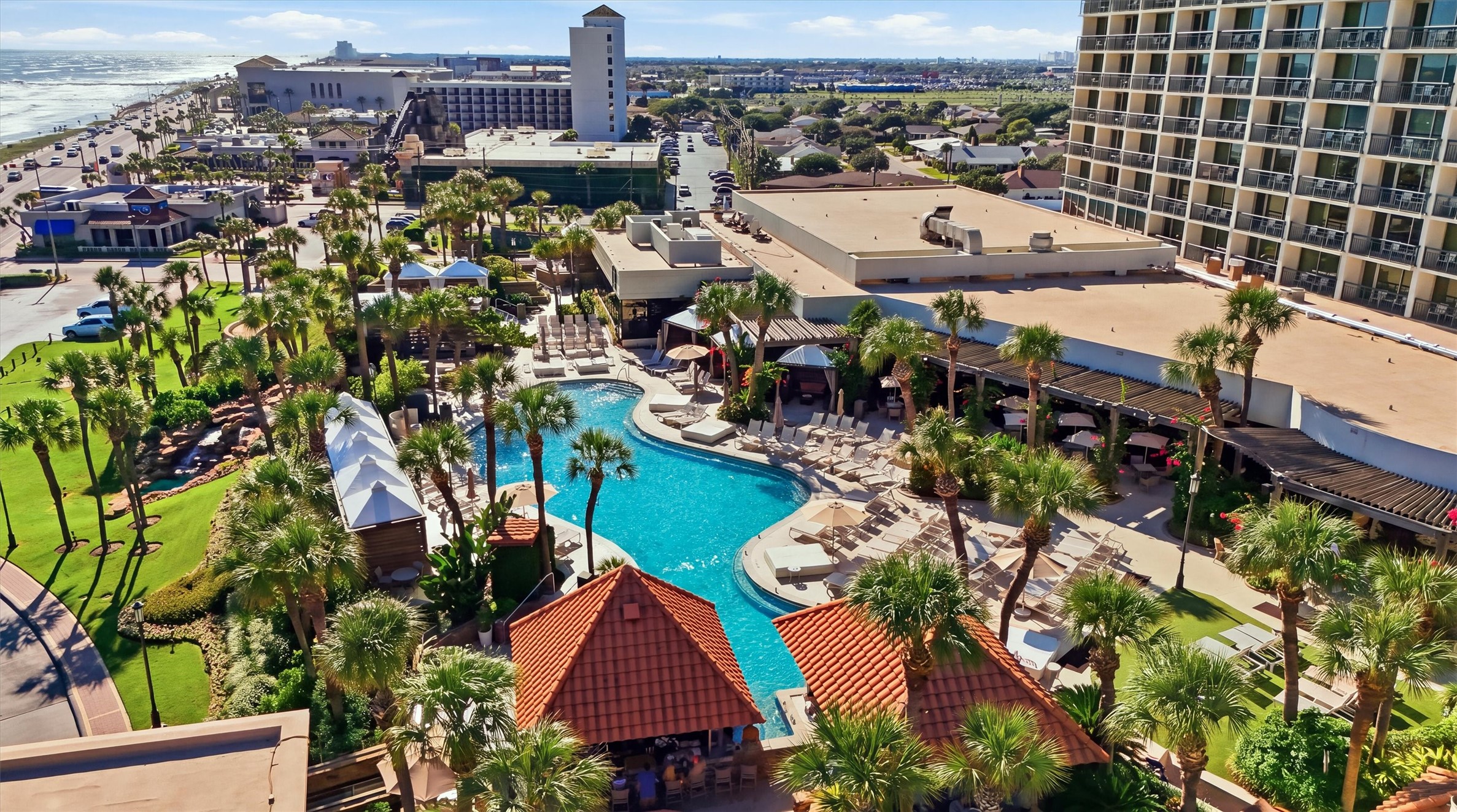 Enjoy a tropical poolside setting surrounded by palm trees, lush landscaping, and inviting lounge areas.