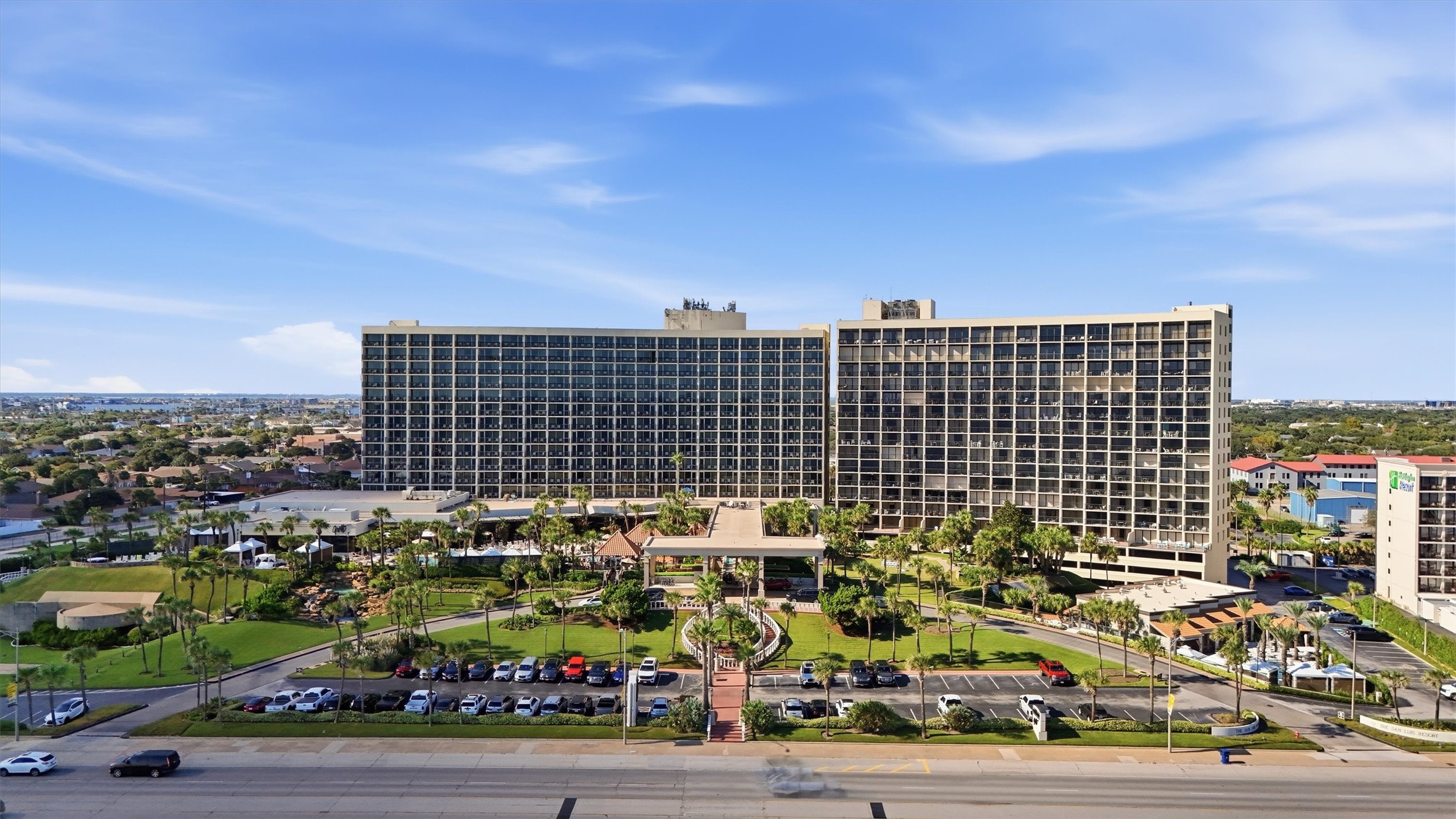 A sweeping exterior view showcases the San Luis and its beautifully landscaped grounds along Seawall Boulevard.
