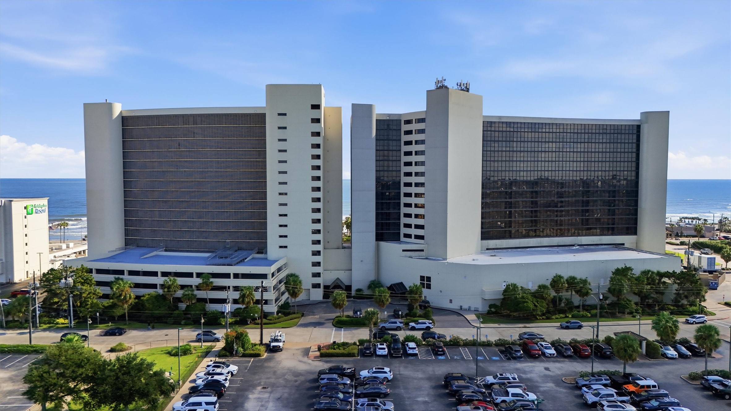 The distinctive San Luis towers rise above palm-lined grounds with the Gulf stretching beyond.