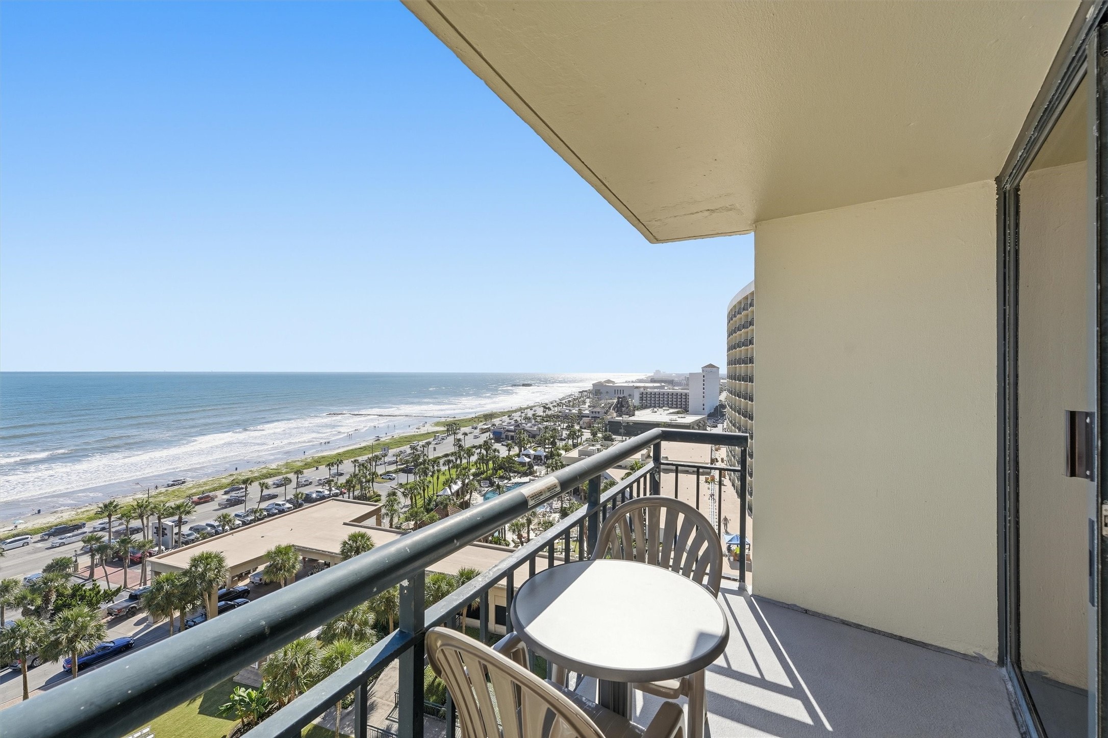 Relax on the covered balcony with sweeping coastal views stretching along Seawall Boulevard.