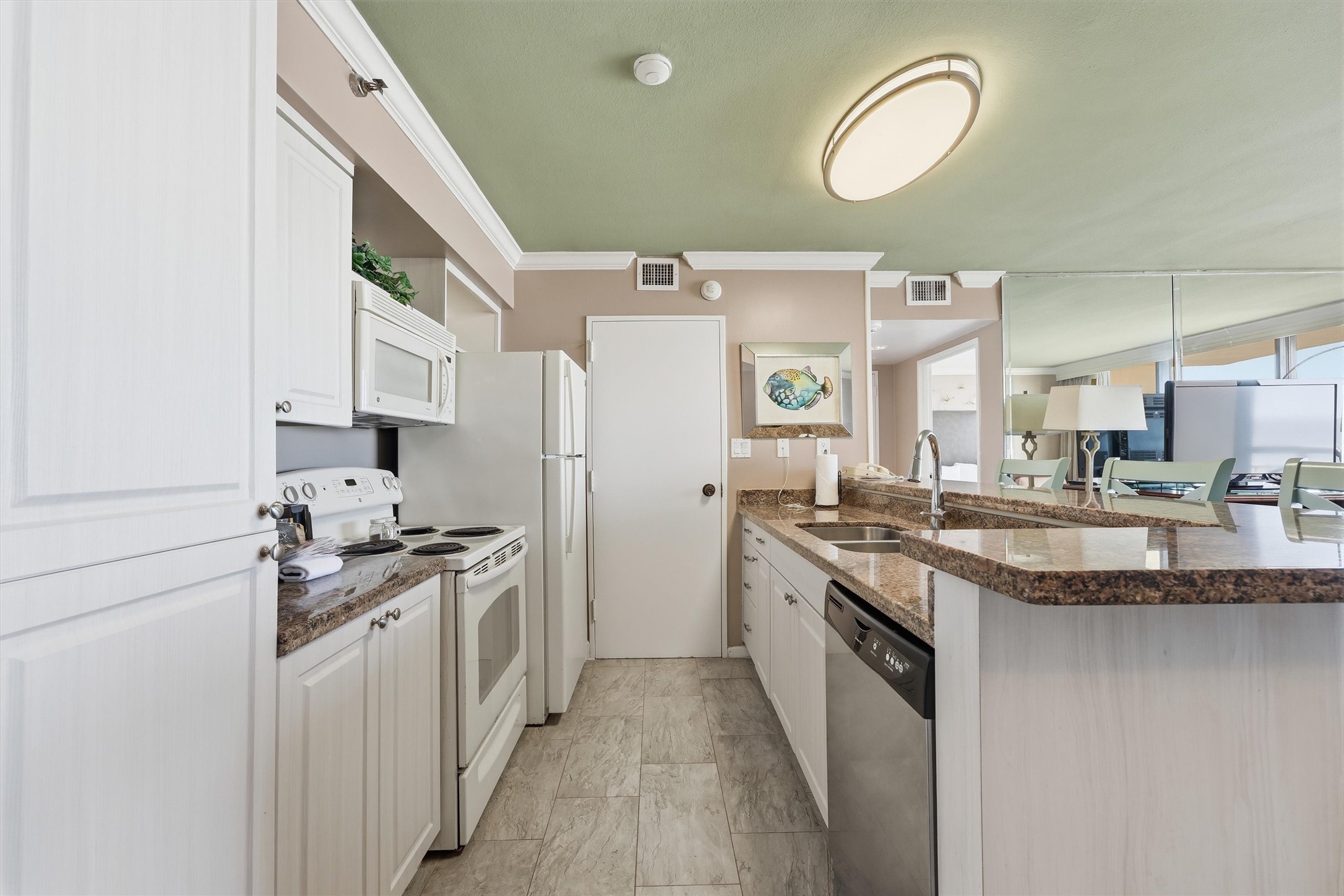 The kitchen offers white cabinetry, generous counter space, and a convenient breakfast bar.