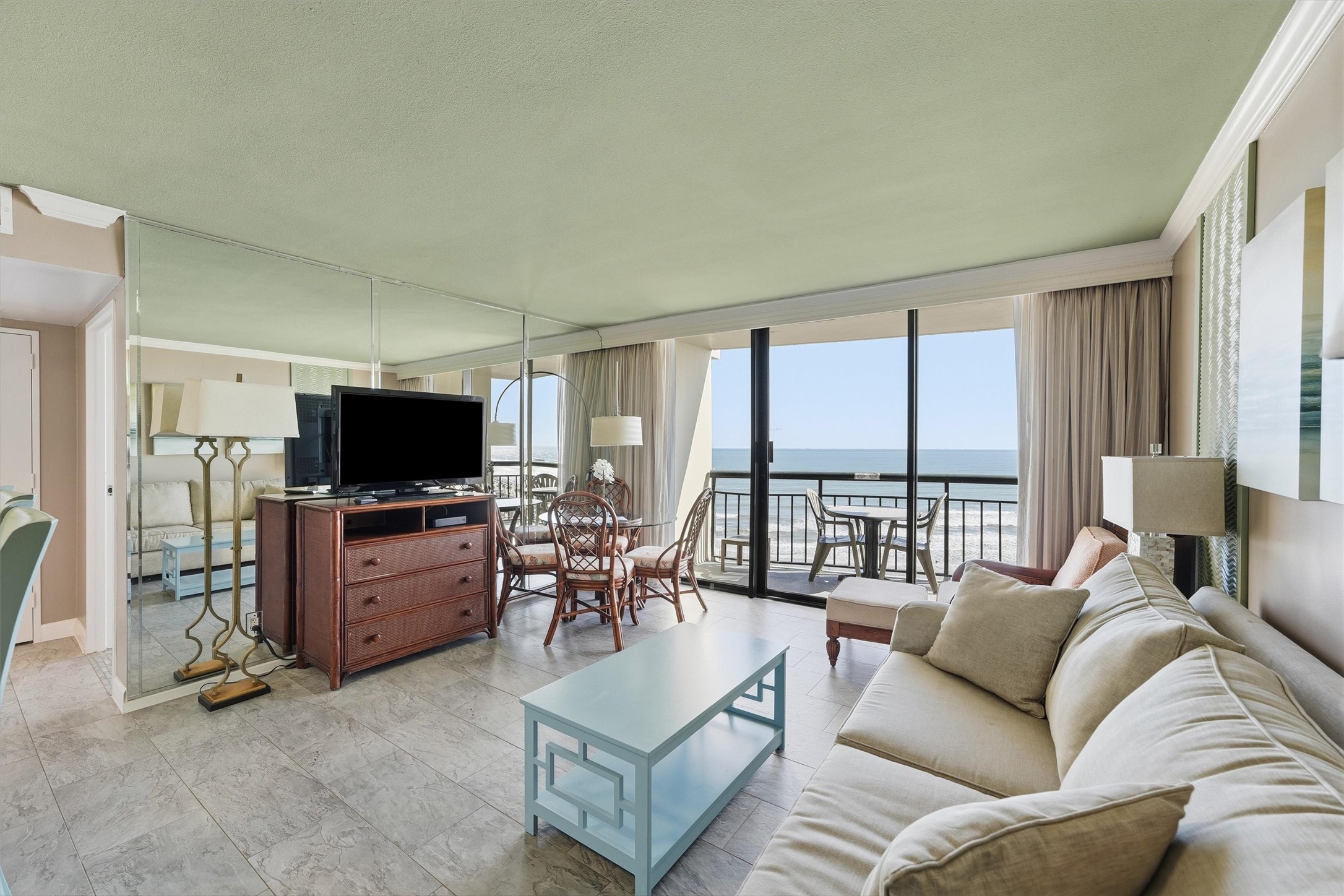 Natural light fills the living area, where sliding glass doors frame beautiful Gulf views.