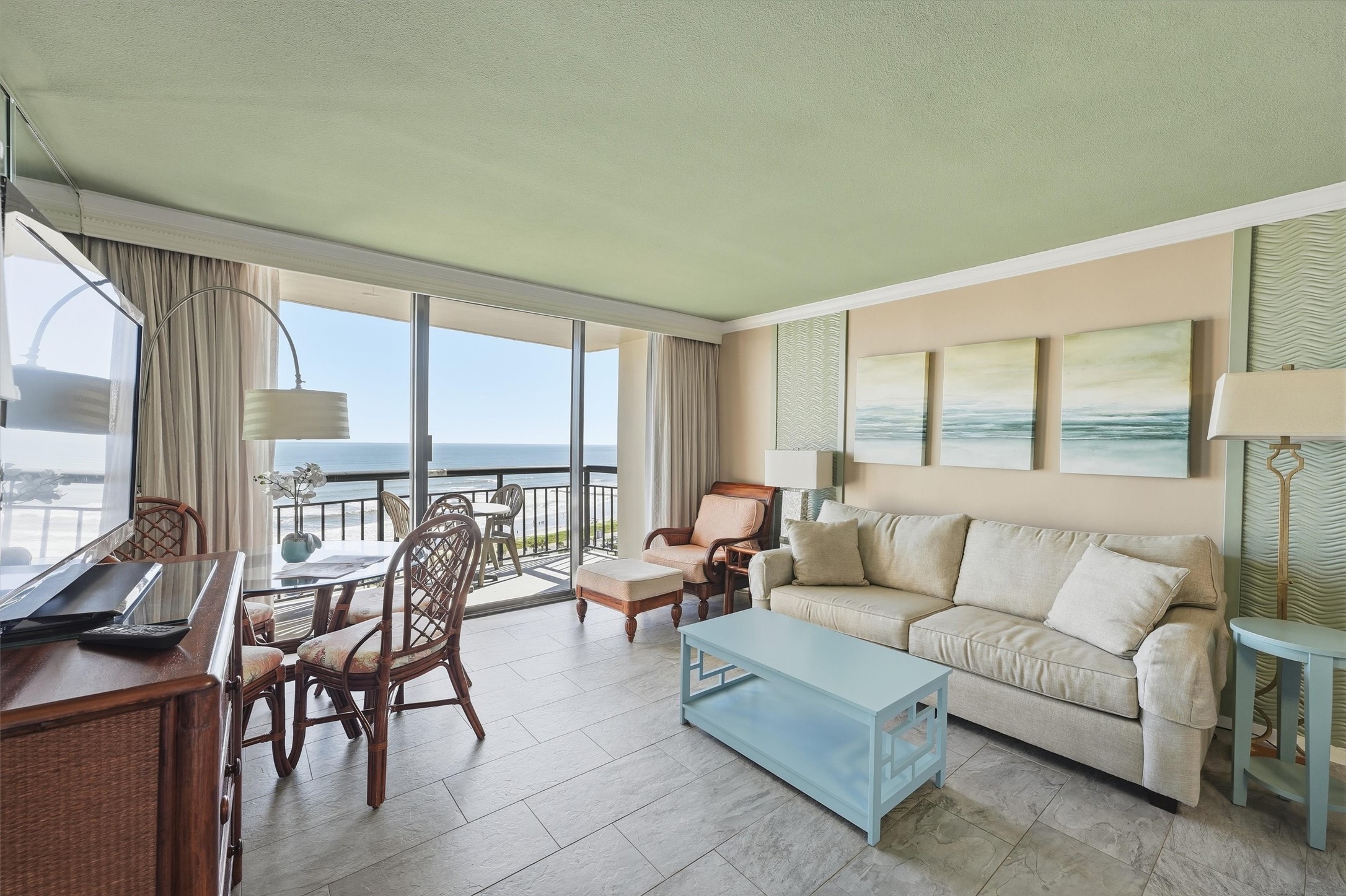 Relax after a day at the beach in this inviting living space with direct balcony access.