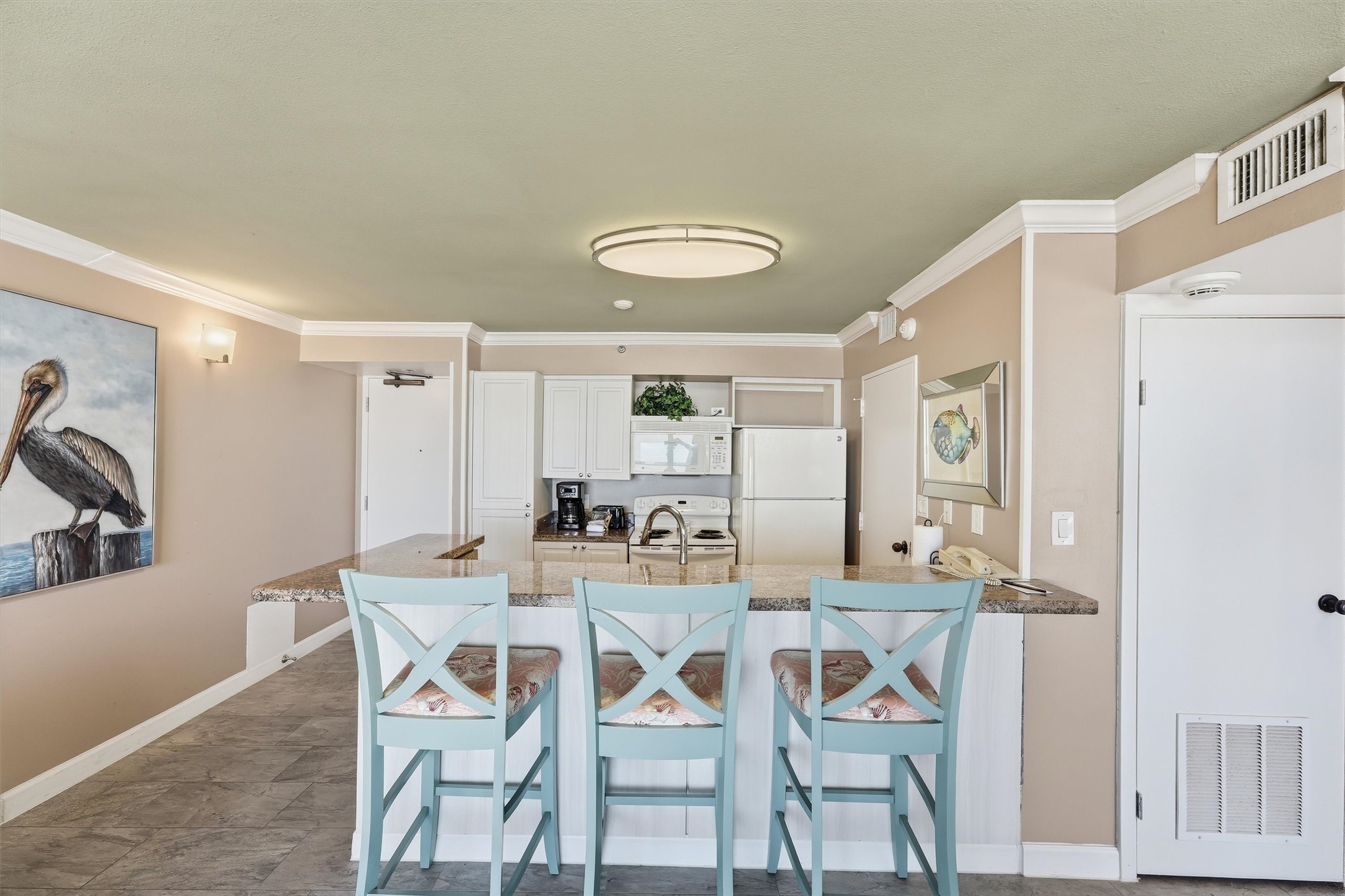 The breakfast bar connects the kitchen and living area, keeping everyone part of the conversation.