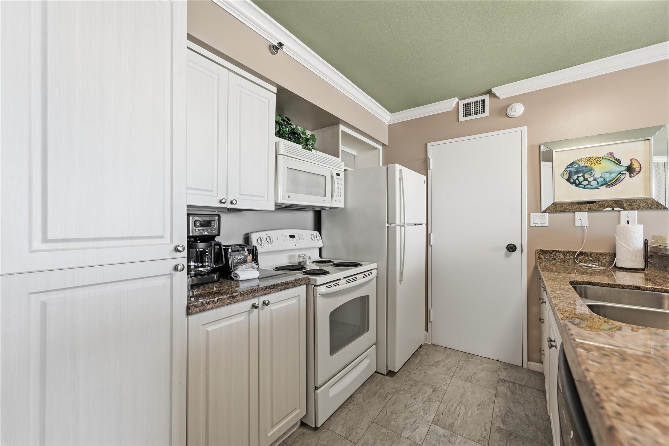 A refrigerator, electric range, and built-in microwave make this kitchen ready for your culinary ventures.
