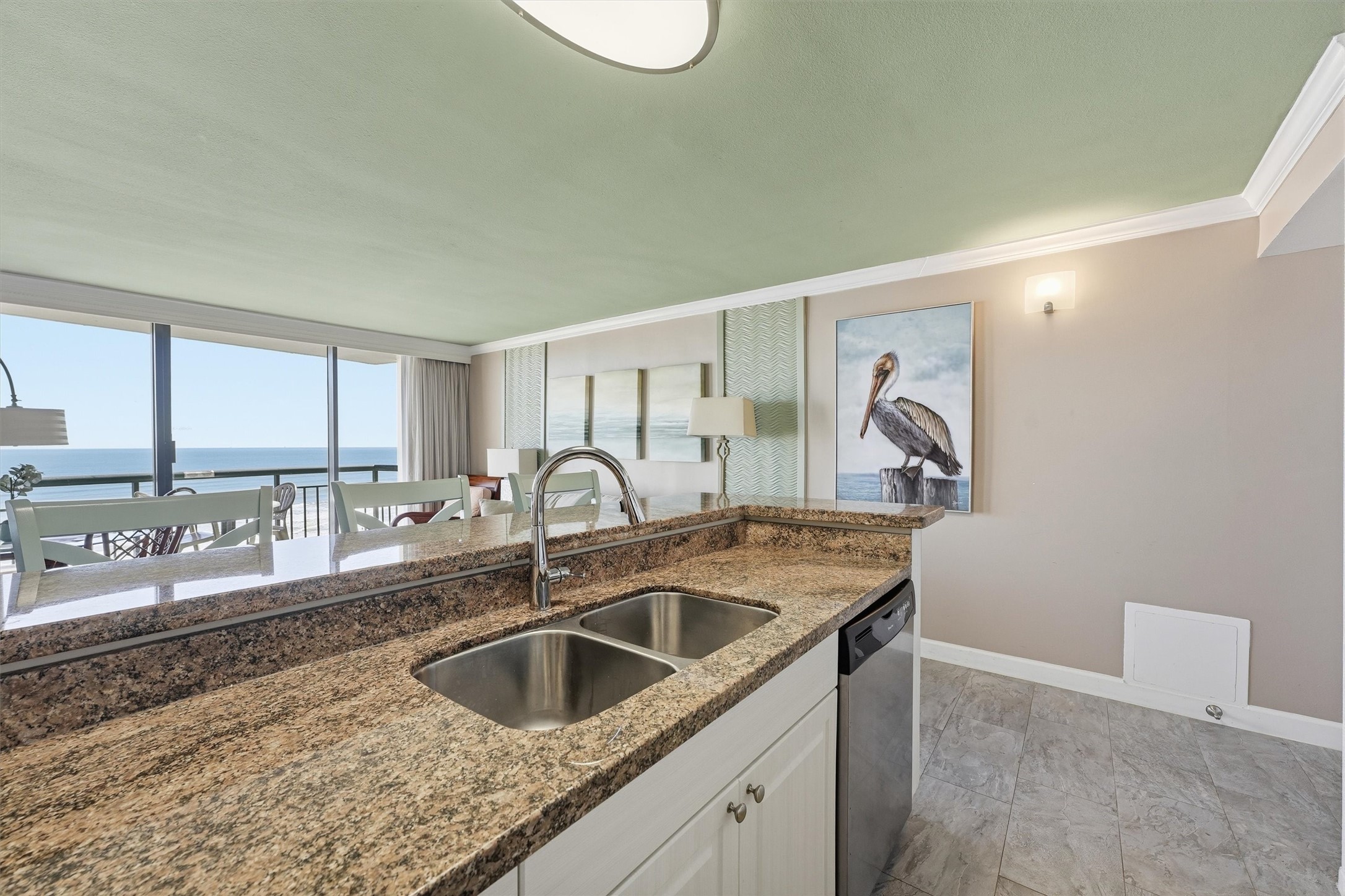Enjoy views of the water from the kitchen, featuring a double-basin sink and an expansive countertop.