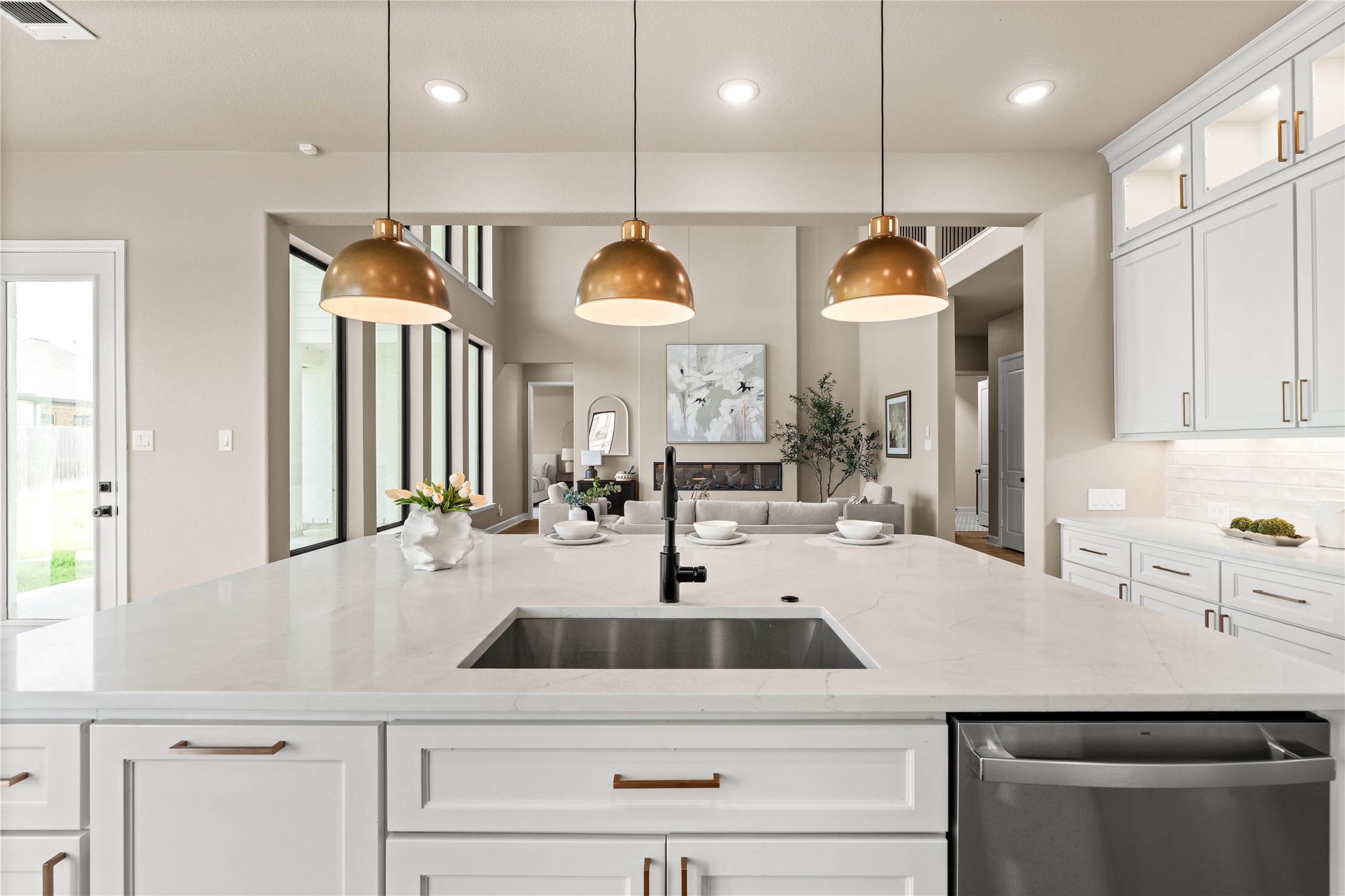 Gorgeous pendant lights and quartz countertops. You can't go wrong with this gourmet kitchen. *Virtually Staged*