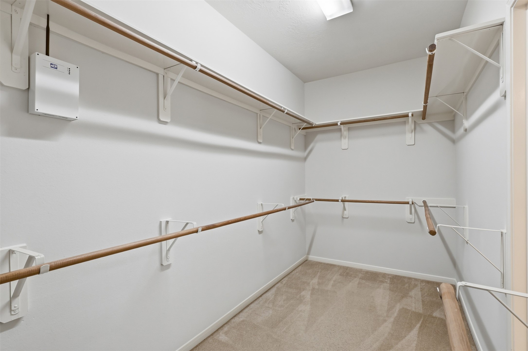 The large walk-in closet provides extensive hanging and storage space for an organized primary suite.