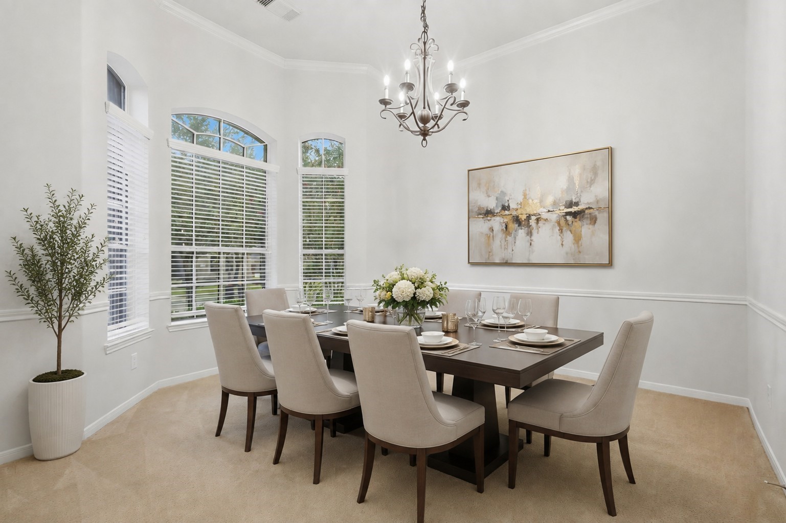 The formal dining room is enhanced by tall arched windows, abundant natural light, crown molding, and elegant architectural detailing.**Virtually staged