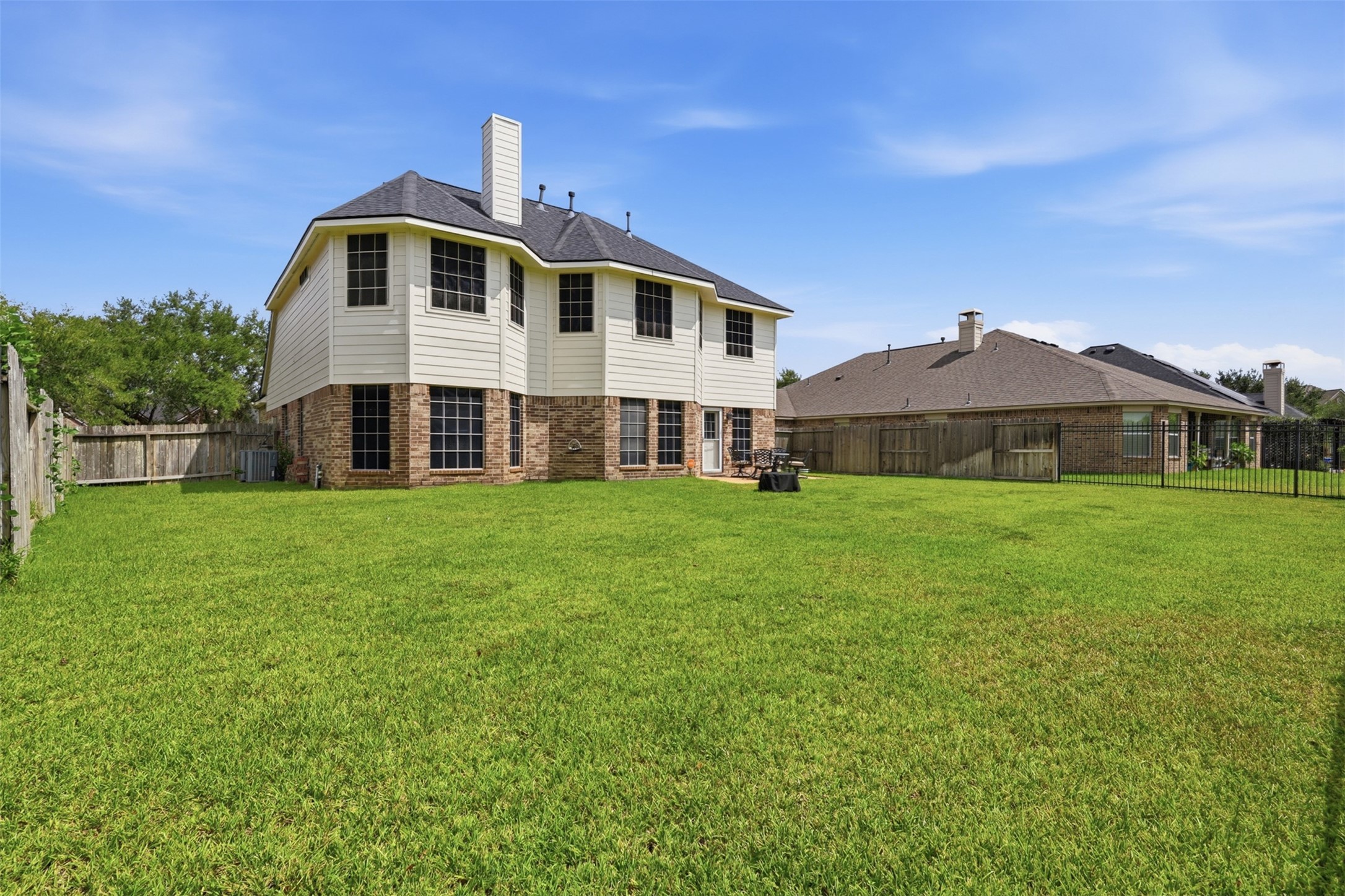 The rear exterior showcases a spacious backyard, two-story elevation, and easy access to the outdoor living area.