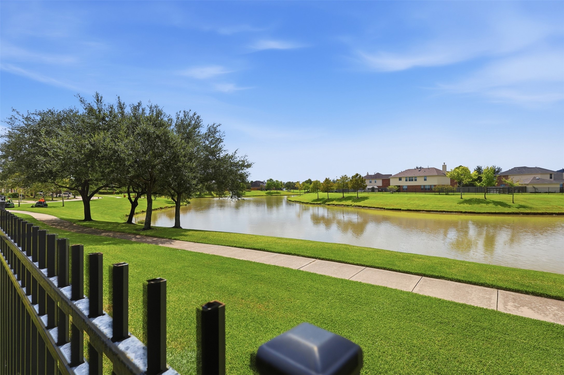 Residents can enjoy peaceful lake views and a paved walking trail surrounded by maintained community green space.