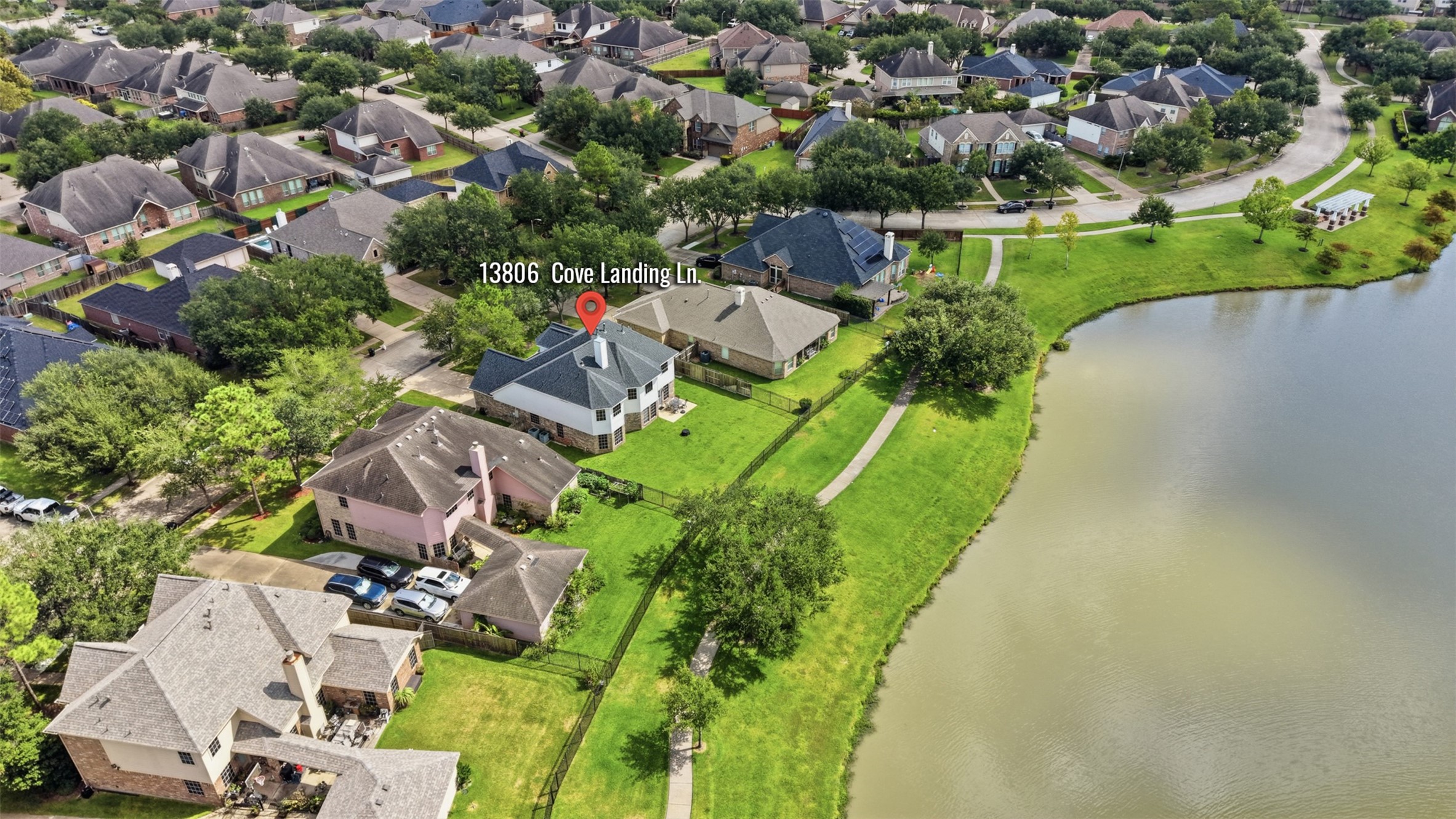 This aerial view shows the property positioned just steps from the lake and neighborhood walking trail.