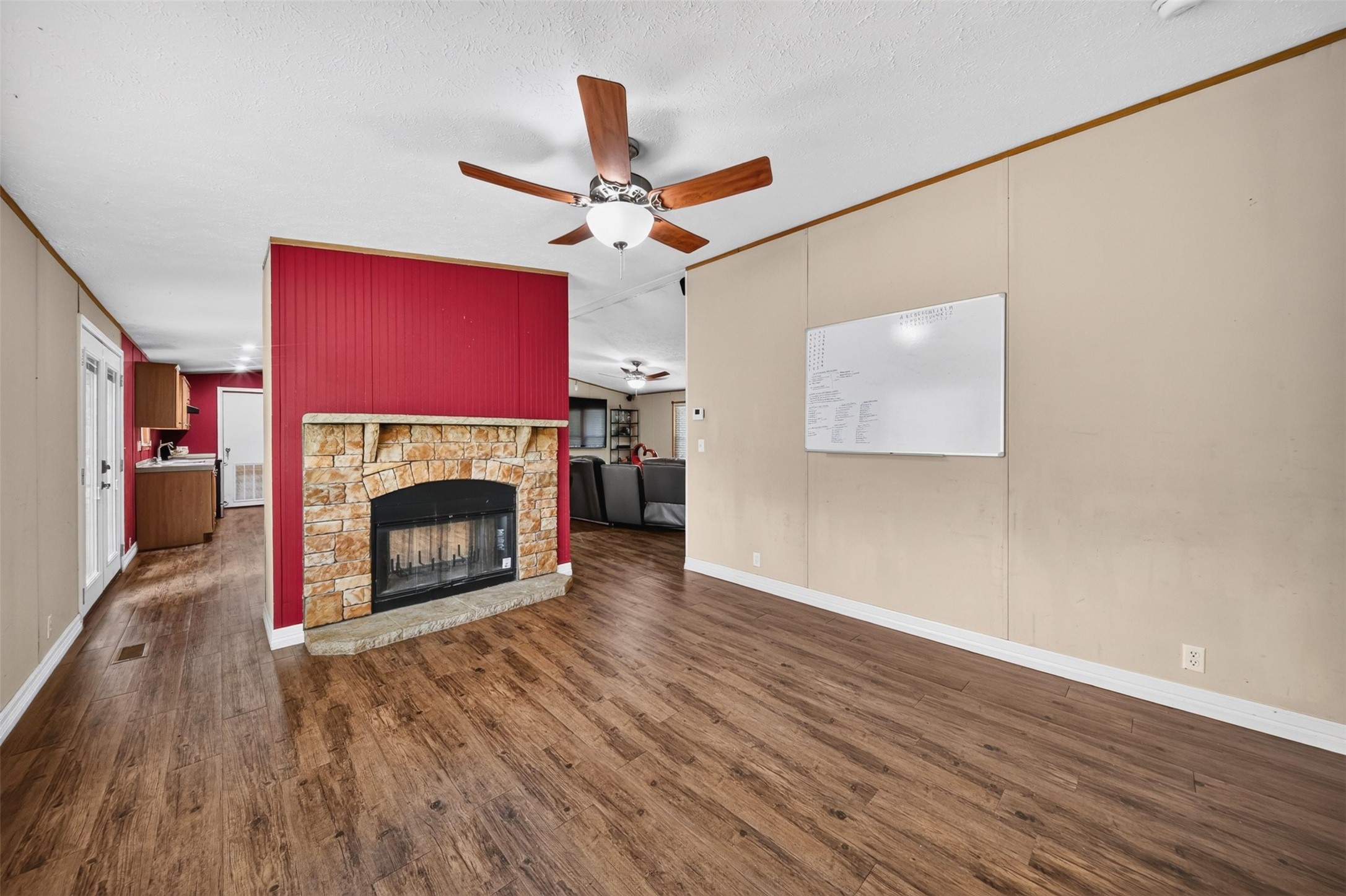 Spacious living area with fireplace and flexible room for multiple furniture arrangements.