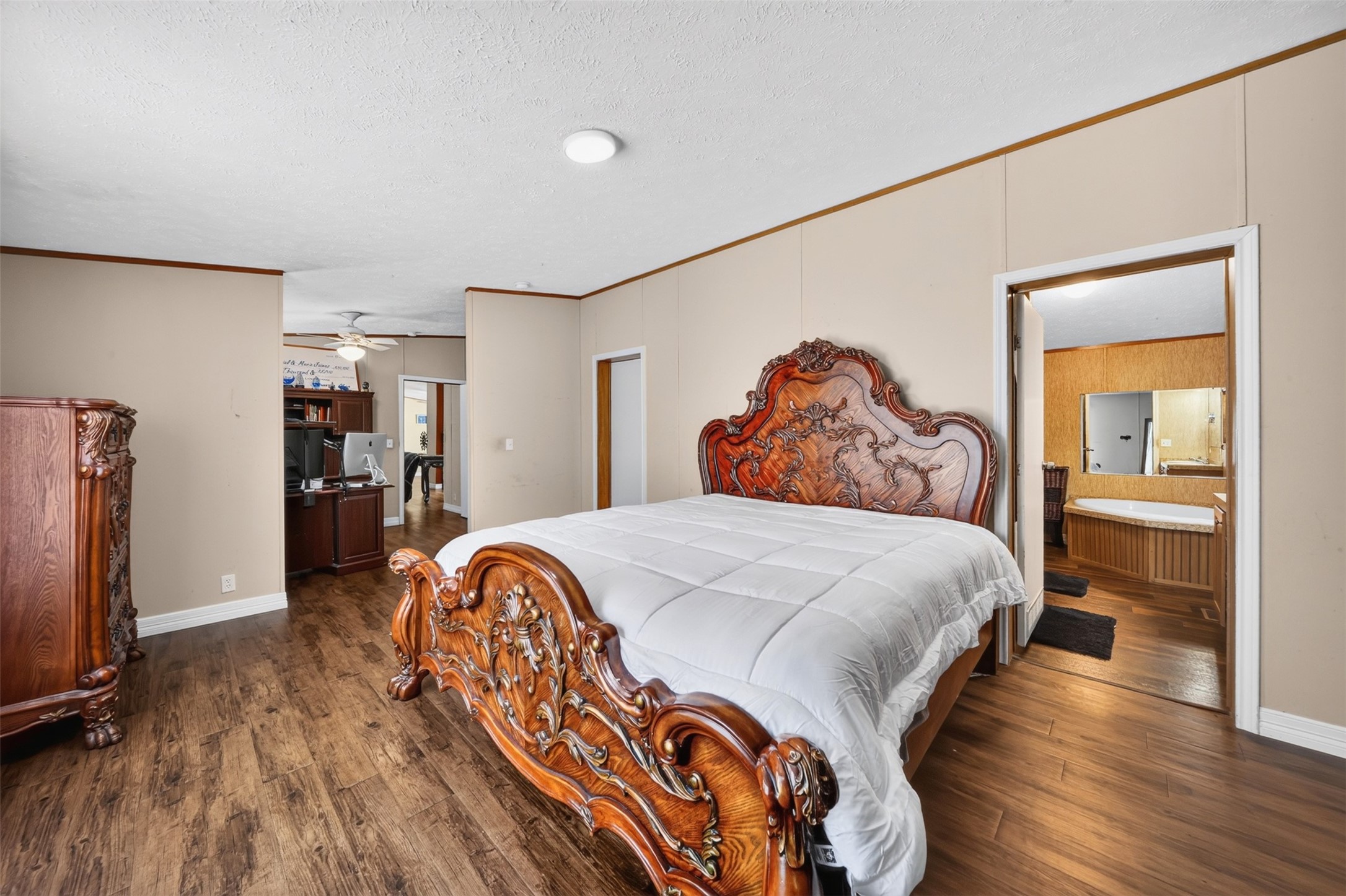 Spacious bedroom with wood-look flooring and room for additional furnishings.