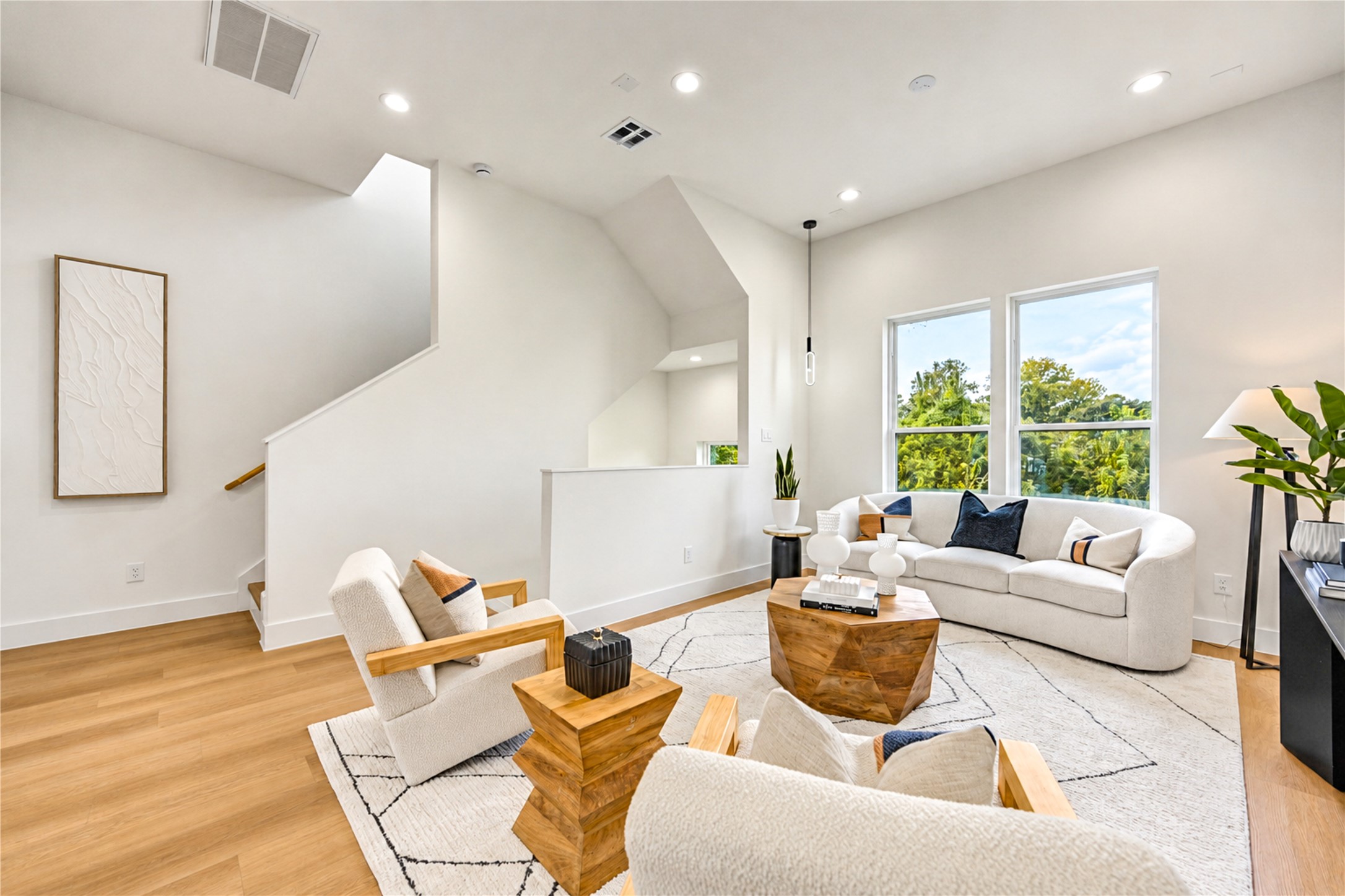 Inviting living room with large windows and abundant natural light perfect for entertaining.