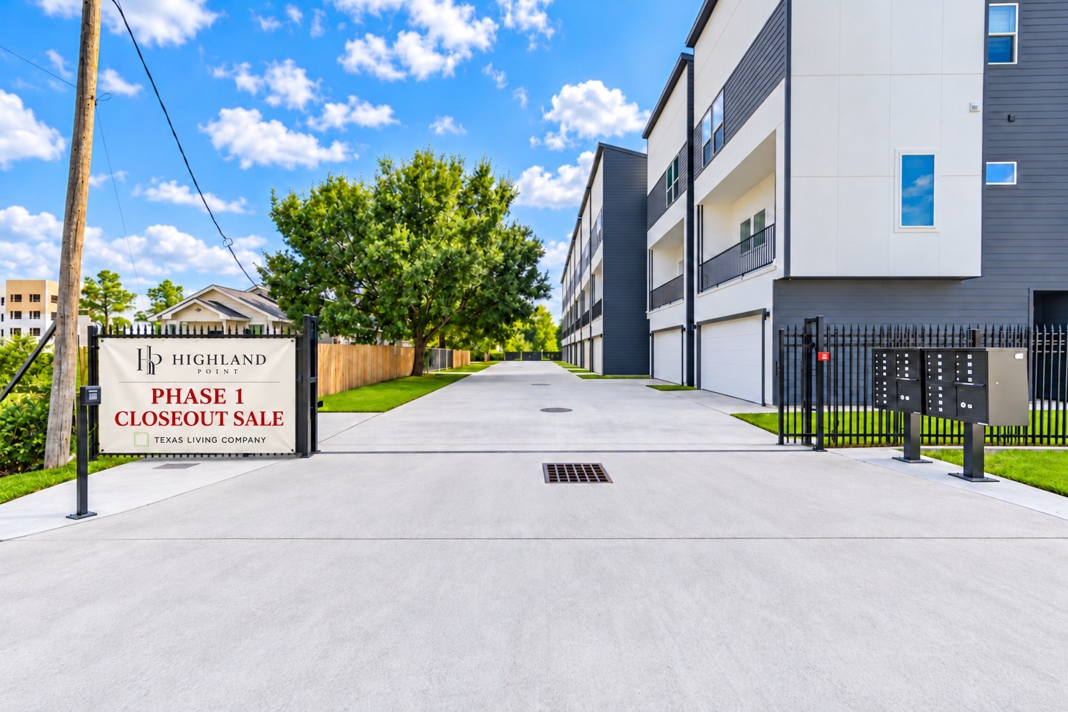 Secure gated entry to Highland Point community featuring wide concrete driveways, designated resident mailboxes. *Sign virtually added