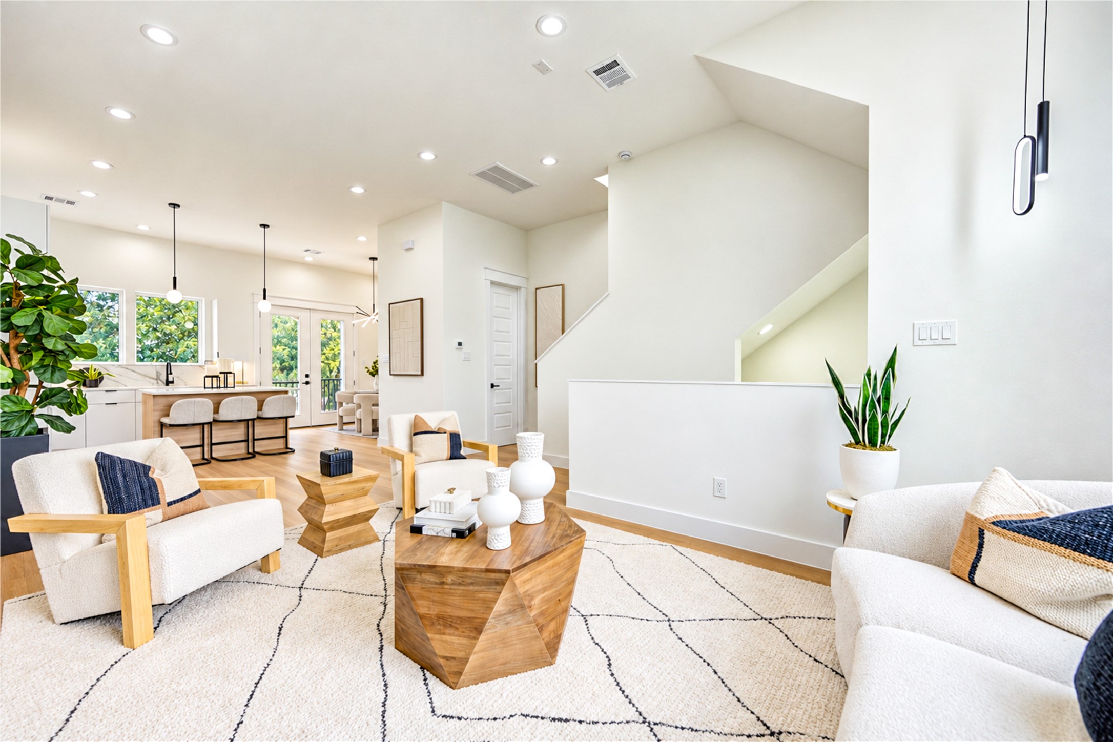 Bright, open living area with 11-foot ceilings and seamless flow to the kitchen and dining space. Bright, open living area with 11-foot ceilings and seamless flow to the kitchen and dining space.