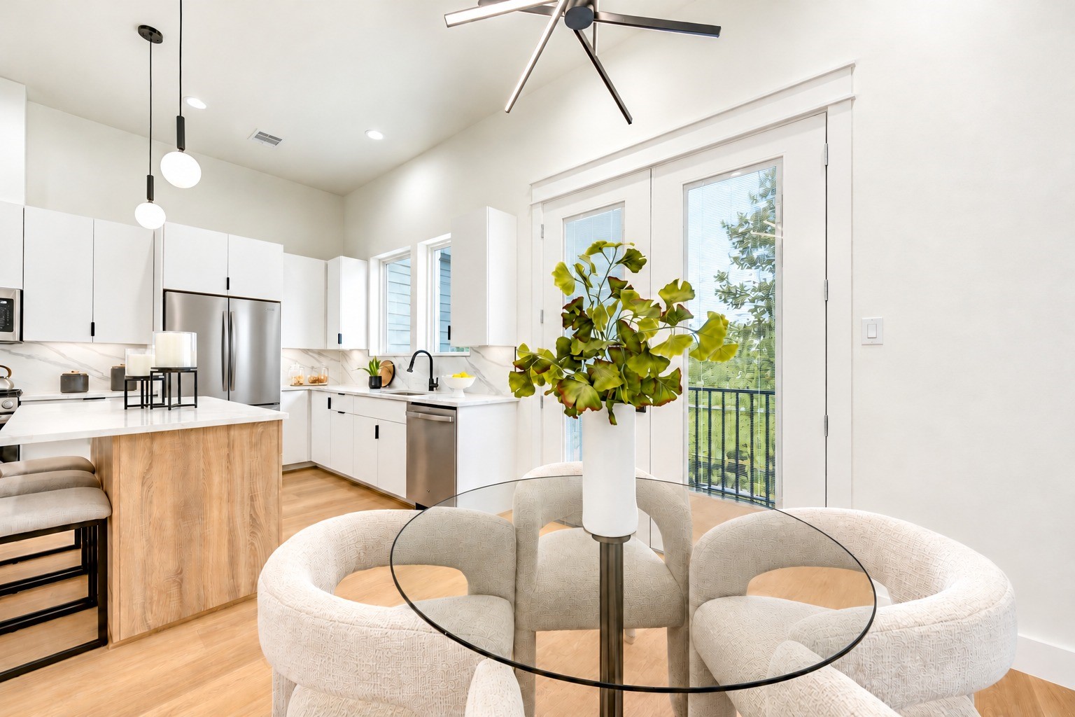 Bright dining area beside the island kitchen, with direct access to the private balcony. *Refrigerator virtually added.