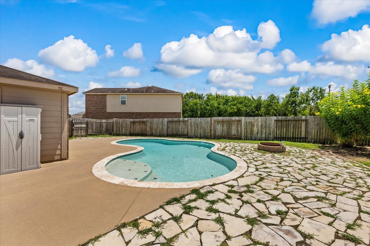 Private backyard oasis featuring a spacious pool situated on an expansive lot.