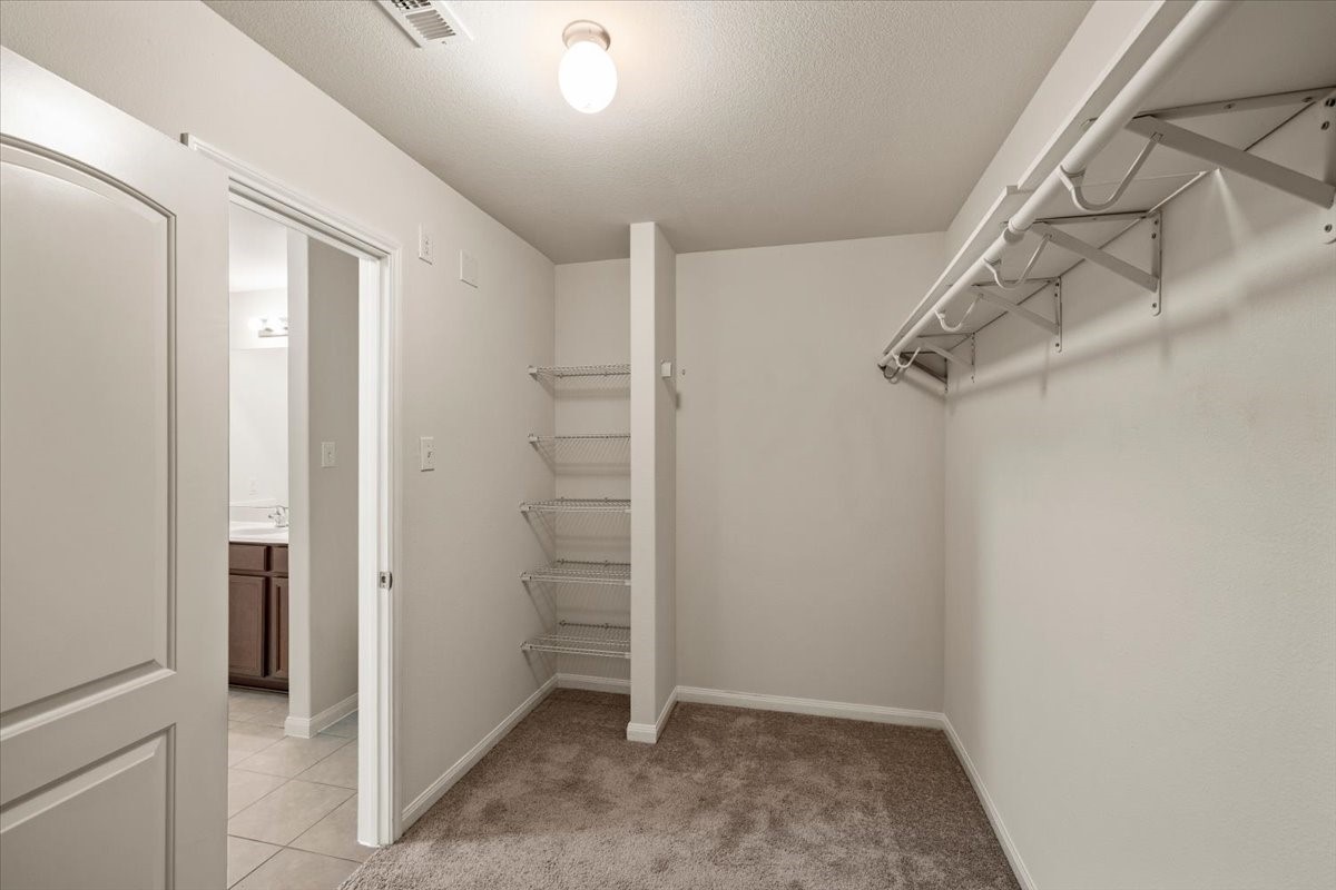 Primary walk in closet with plenty of space