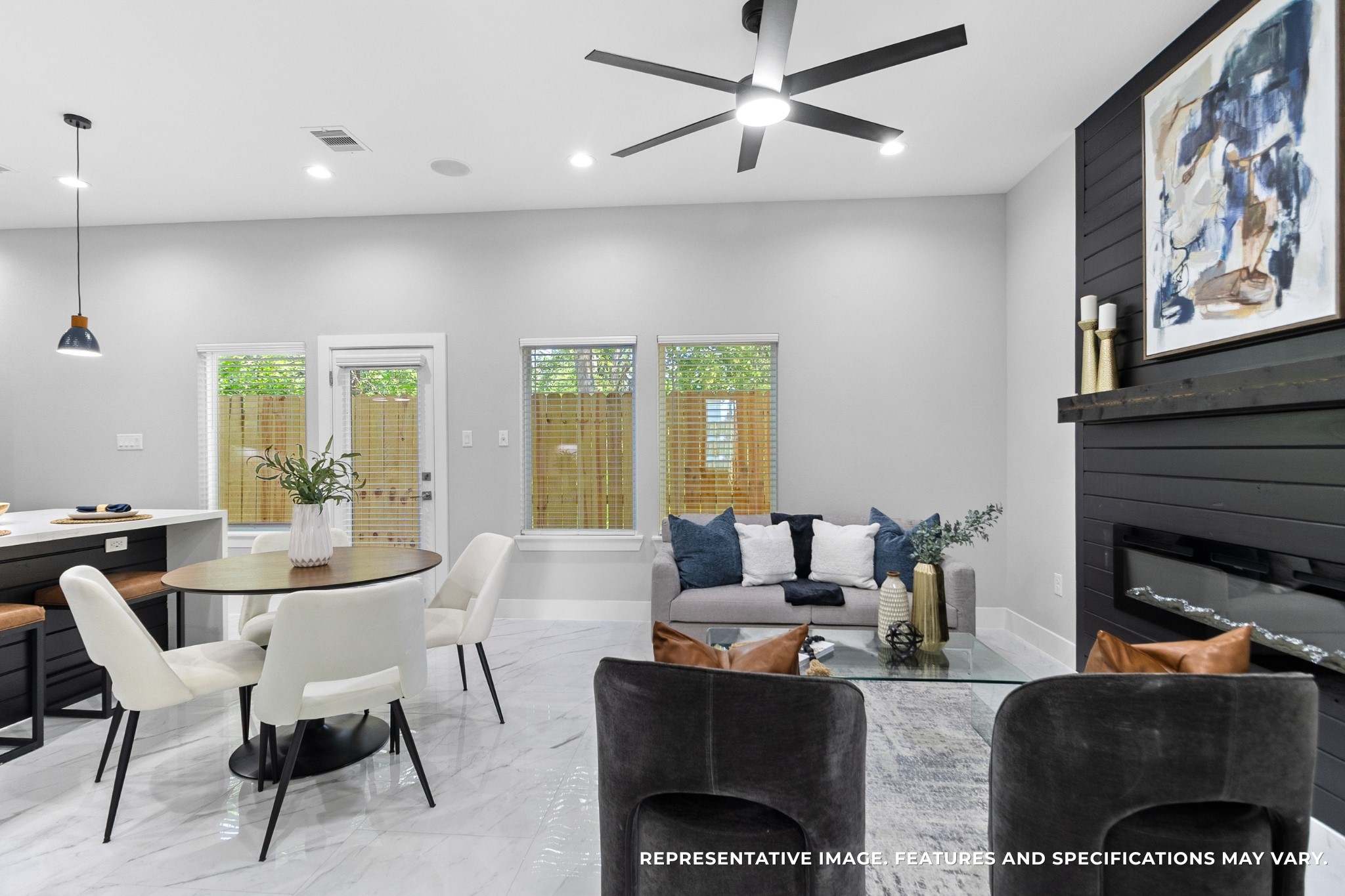 Morning coffee at your round table feels easy here, sunlight streaming in through the windows while the open flow keeps you connected to the living room and kitchen.