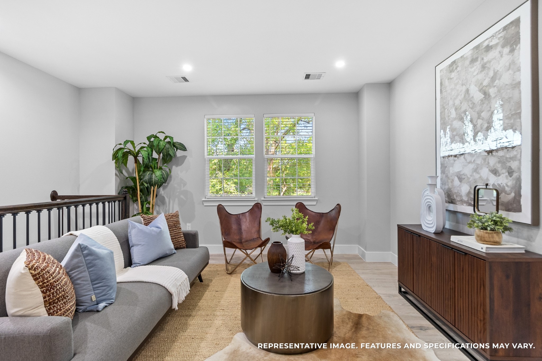 Sunlight pours through the windows, making the loft feel bright and welcoming, a cozy spot to spend lazy afternoons.