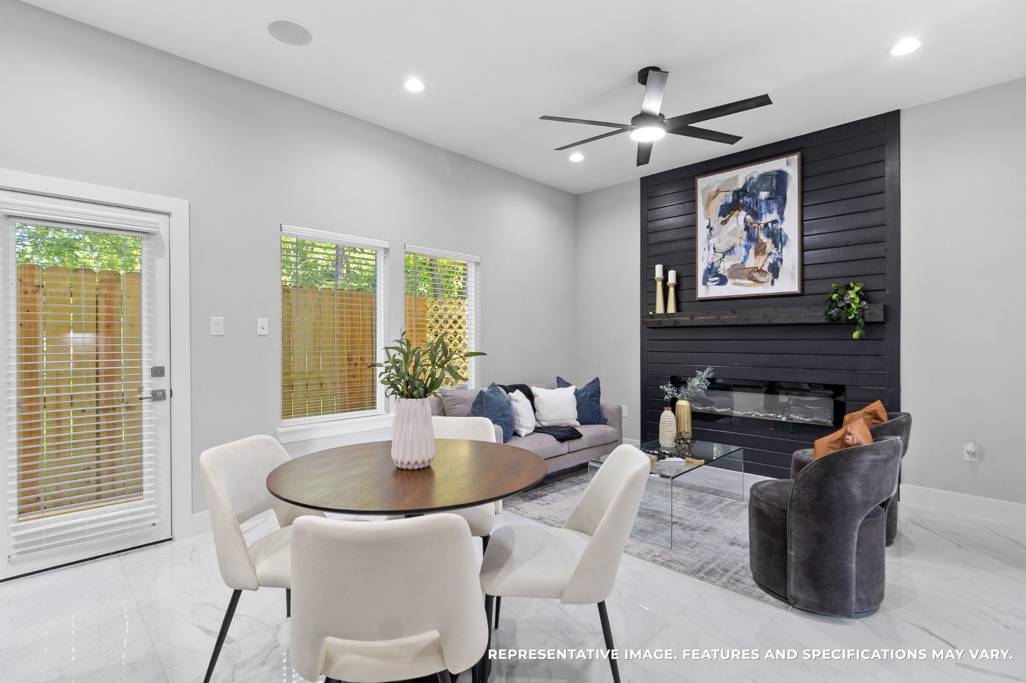 From your dining area, you love the way the fireplace wall anchors the roomevery meal feels cozy with that modern focal point nearby.