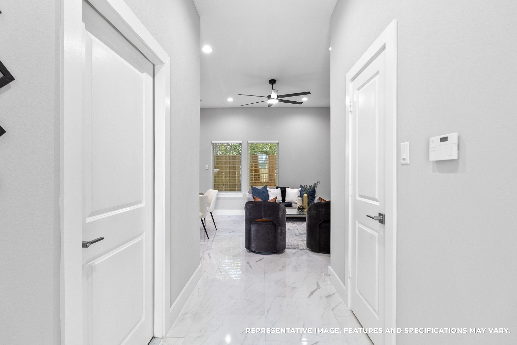 Walking through the entry, you love how the hallway opens into your bright living space, the glossy tile floors reflecting light and leading guests right into the heart of your home.