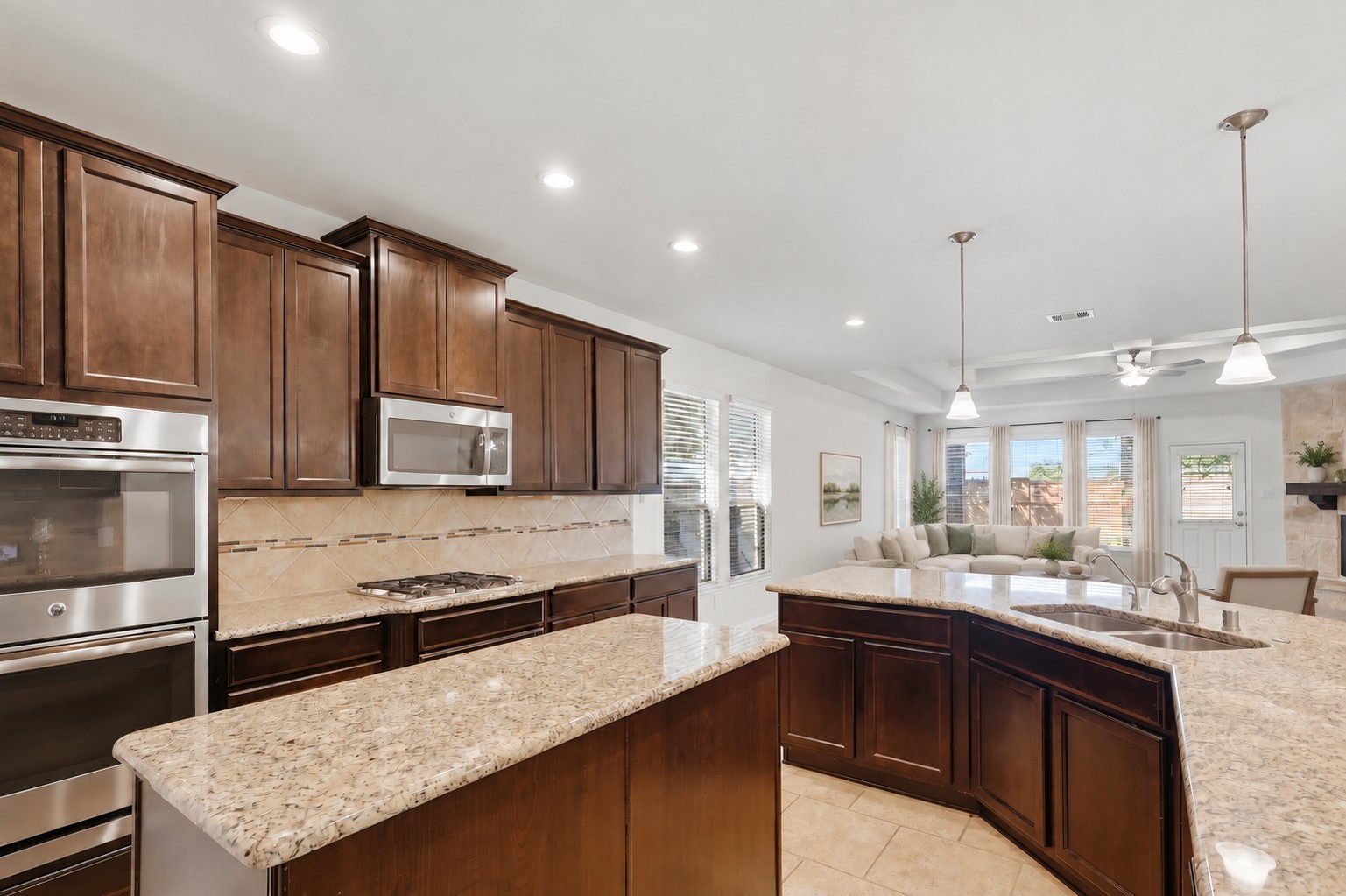 A Kitchen Any Cook Will Appreciate! This fabulous gourmet kitchen offers rich custom cabinetry, beautiful granite countertops, a generous breakfast bar, stainless steel appliances, and plenty of workspace. The open design connects beautifully with the casual dining and family room, making everyday living and entertaining wonderfully easy. *Photo is virtually staged*