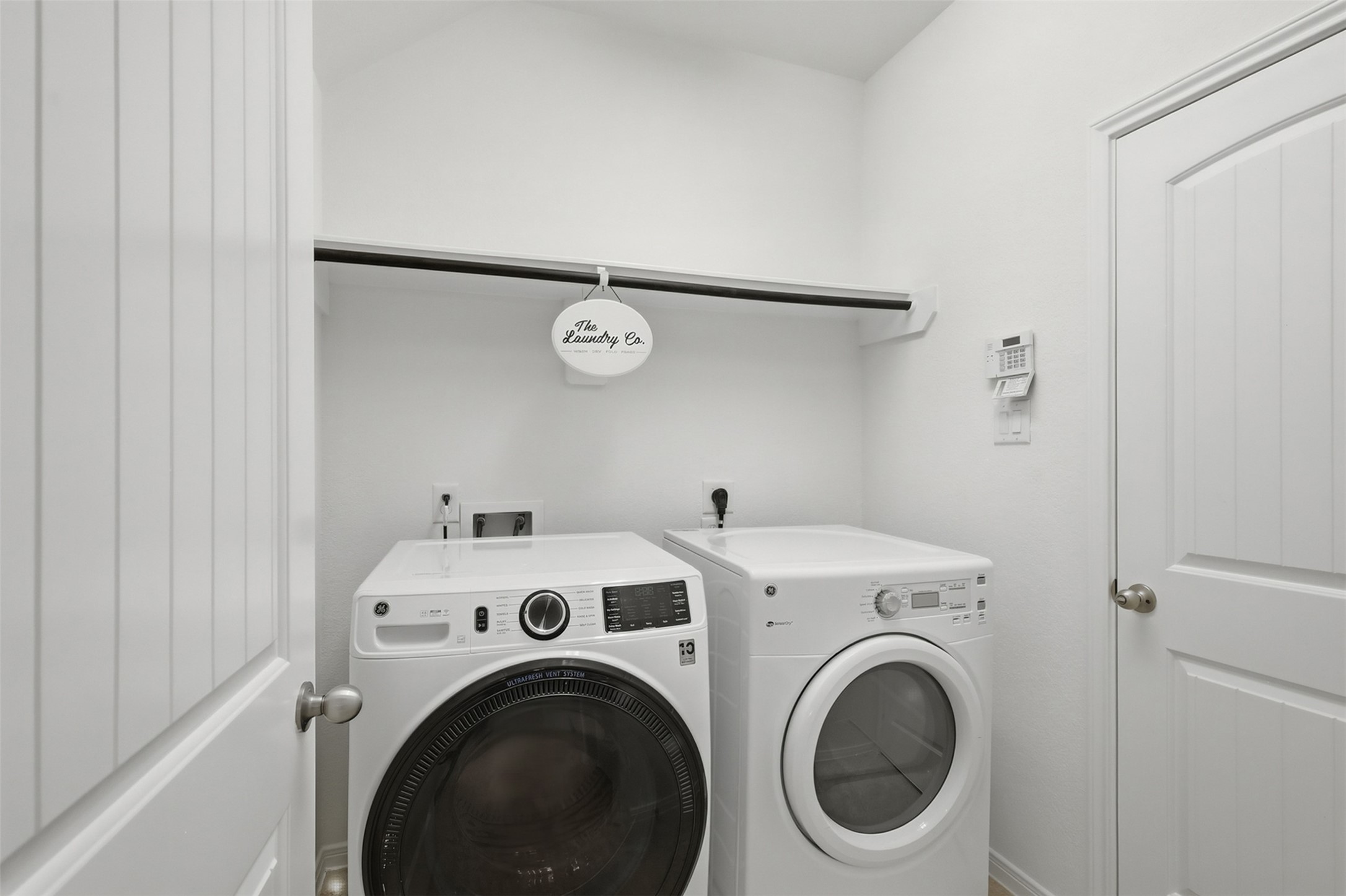 A Bright & Practical Utility Room! The spacious utility room provides room for your washer and dryer along with convenient storage and workspace. Bright walls, a clean layout, and a handy hanging area make everyday laundry chores just a little easier.