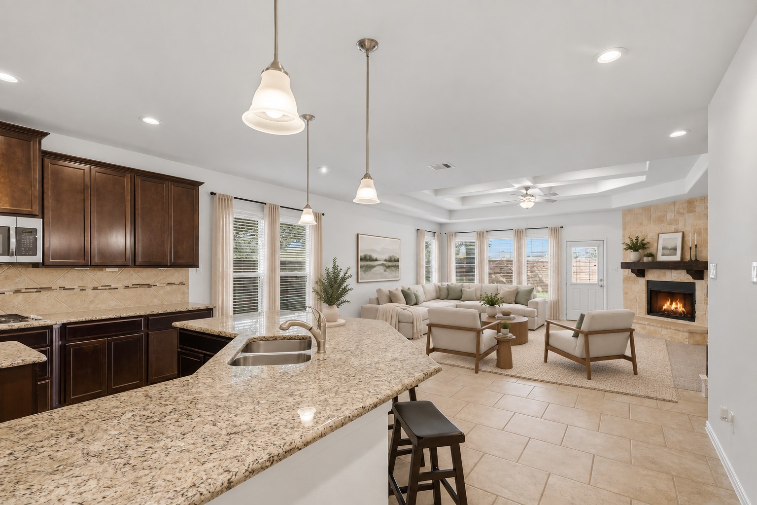 The Heart of the Home! This spacious open-concept kitchen flows beautifully into the family room, creating the perfect gathering space. The large island, granite countertops, custom cabinetry, pendant lighting, and stainless steel appliances make this kitchen as beautiful as it is practical. And I especially love how easily everyone can stay connected while cooking, dining, and relaxing! *Photo is virtually staged* The Heart of the Home! This spacious open-concept kitchen flows beautifully into the family room, creating the perfect gathering space. The large island, granite countertops, custom cabinetry, pendant lighting, and stainless steel appliances make this kitchen as beautiful as it is practical. And I especially love how easily everyone can stay connected while cooking, dining, and relaxing! *Photo is virtually staged*