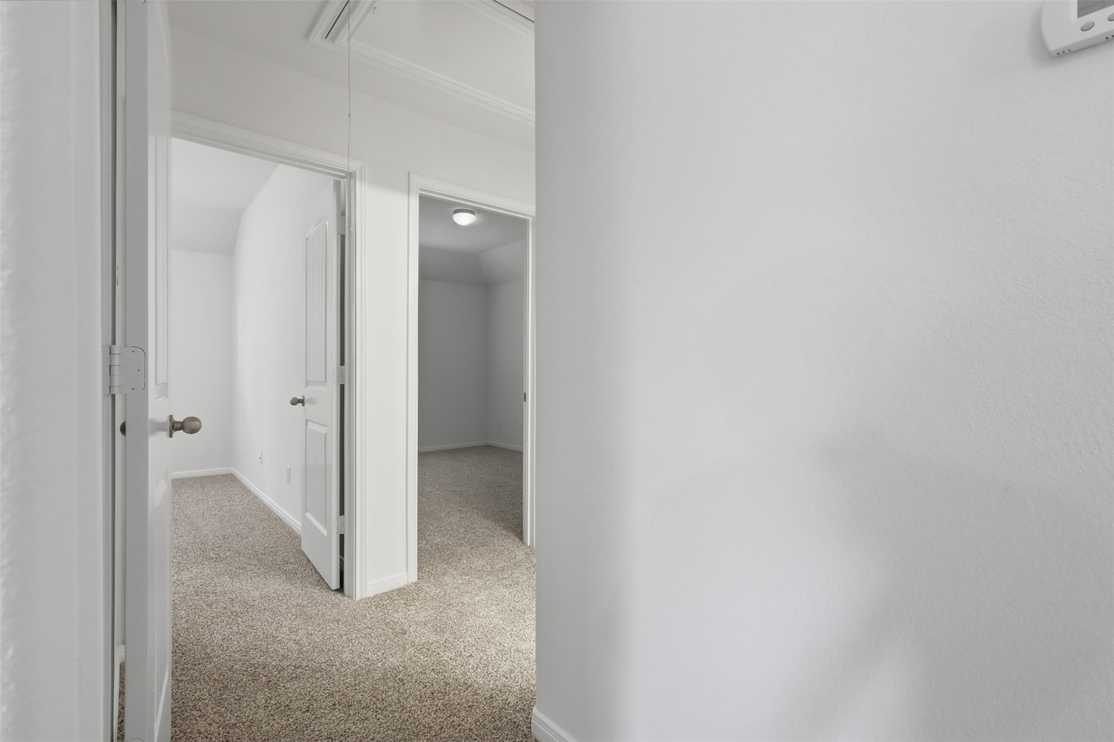 Convenient Upstairs Hallway! This bright hallway provides easy access to the upstairs bedrooms and surrounding spaces. Plush carpeting, clean neutral finishes, and multiple doorways create a practical layout while maintaining the comfortable feel found throughout the home.